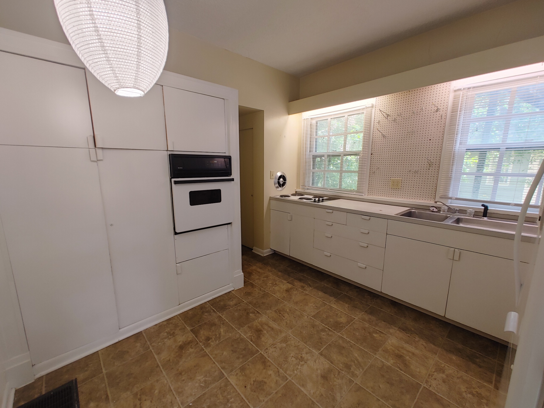 2026 Iuka Ave B eat-in kitchen with wall oven, cooktop, and double sink under bright windows