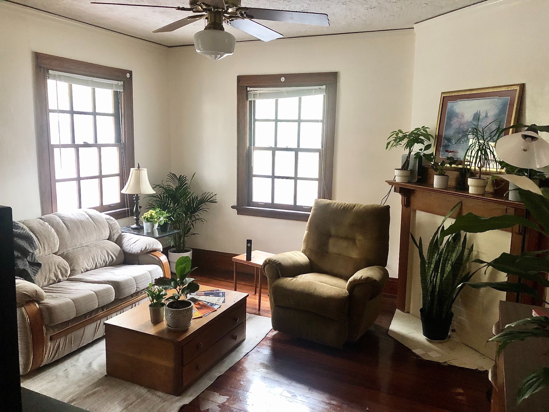 2026 Iuka Ave C furnished living room with fireplace mantel, tall windows, and ceiling fan