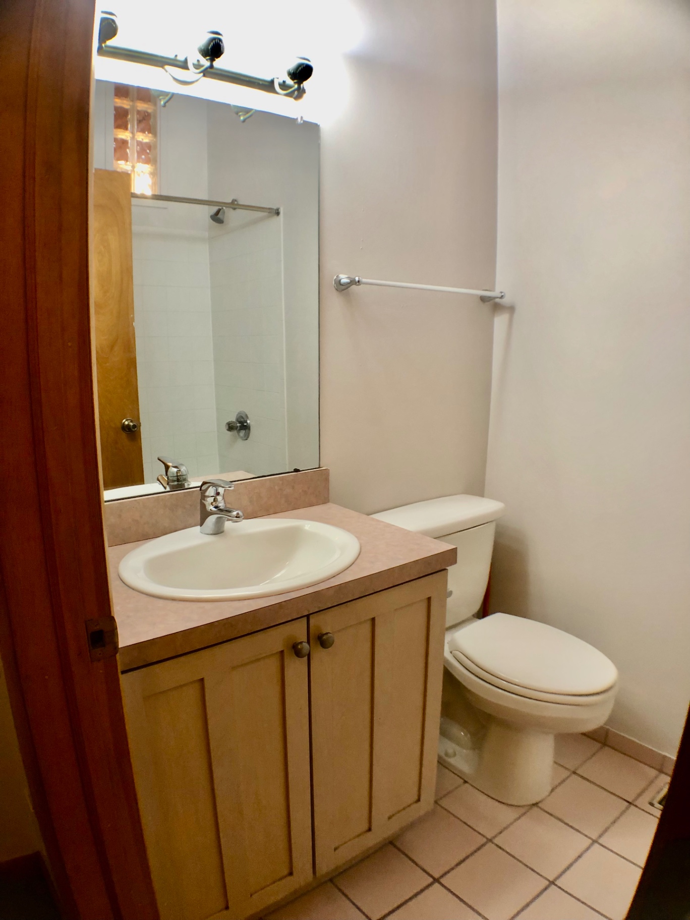2040 Iuka Ave House bathroom with wood vanity, mirror, and tile floor