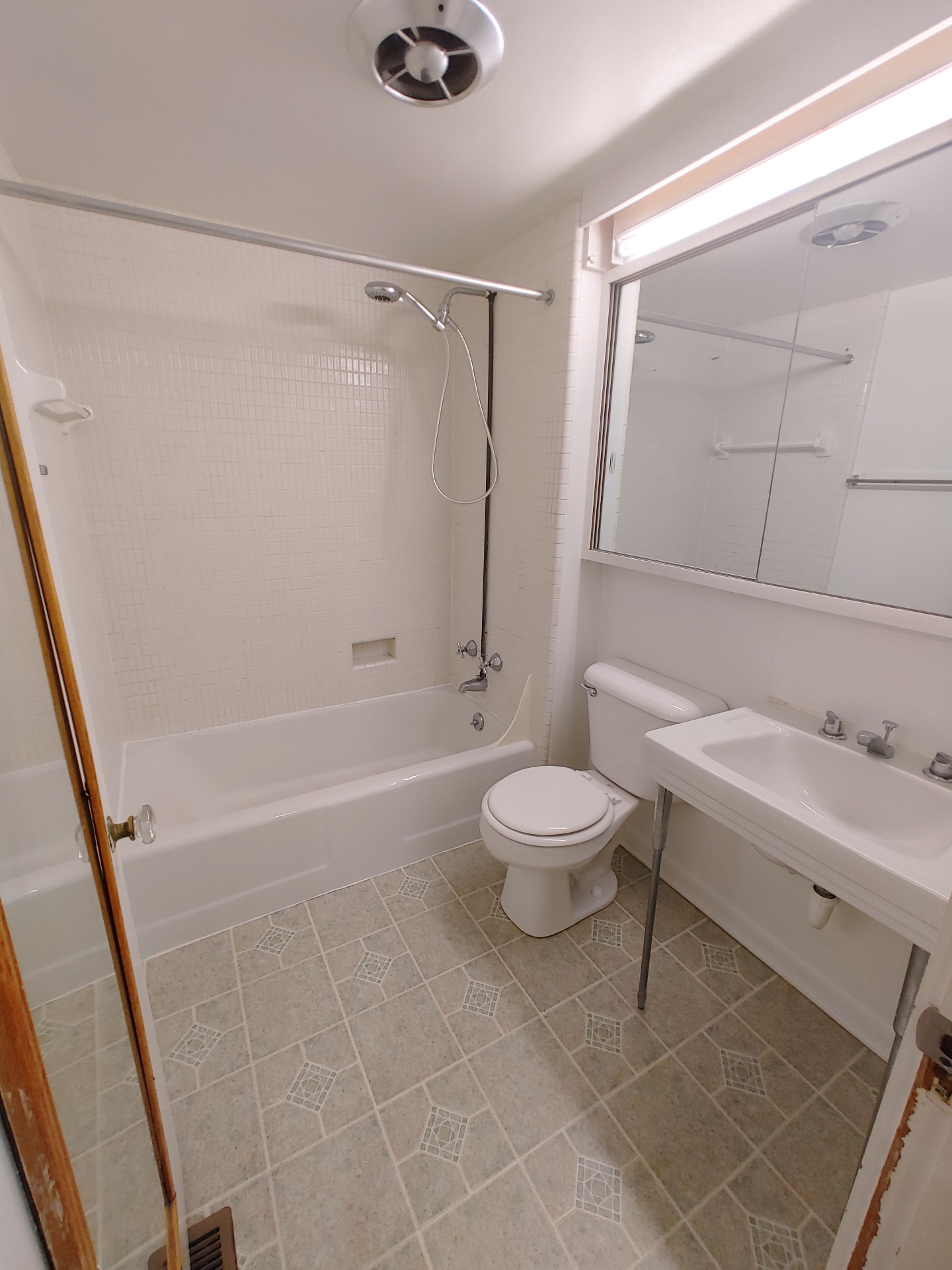 2026 Iuka Ave B full bath with white tile, tub/shower, and large vanity mirror