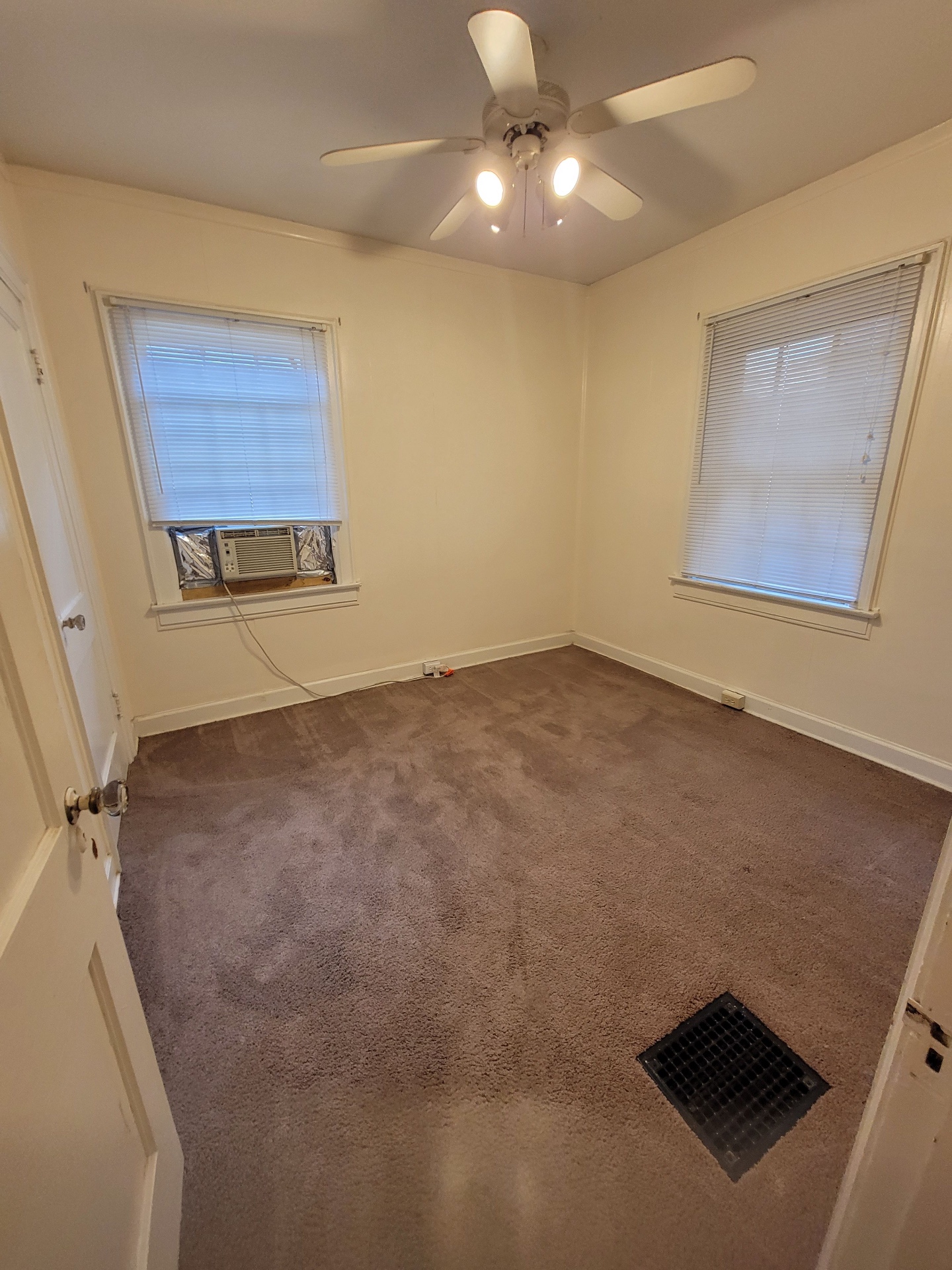 2048 Iuka Ave. B bedroom with ceiling fan, two windows, and window A/C