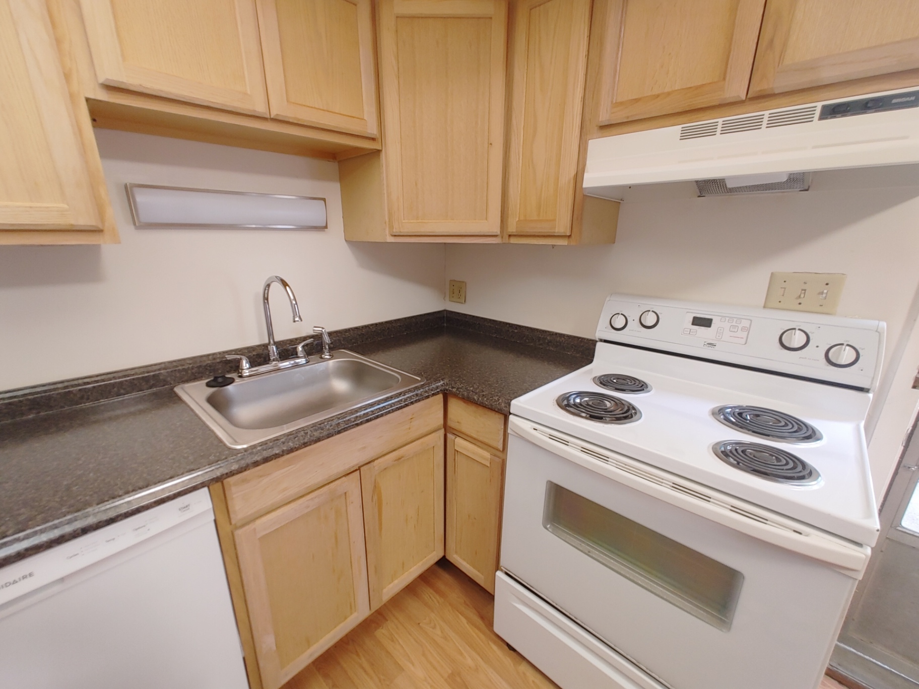 2020 Iuka Ave. kitchen with granite-look counters, stainless sink, and white range