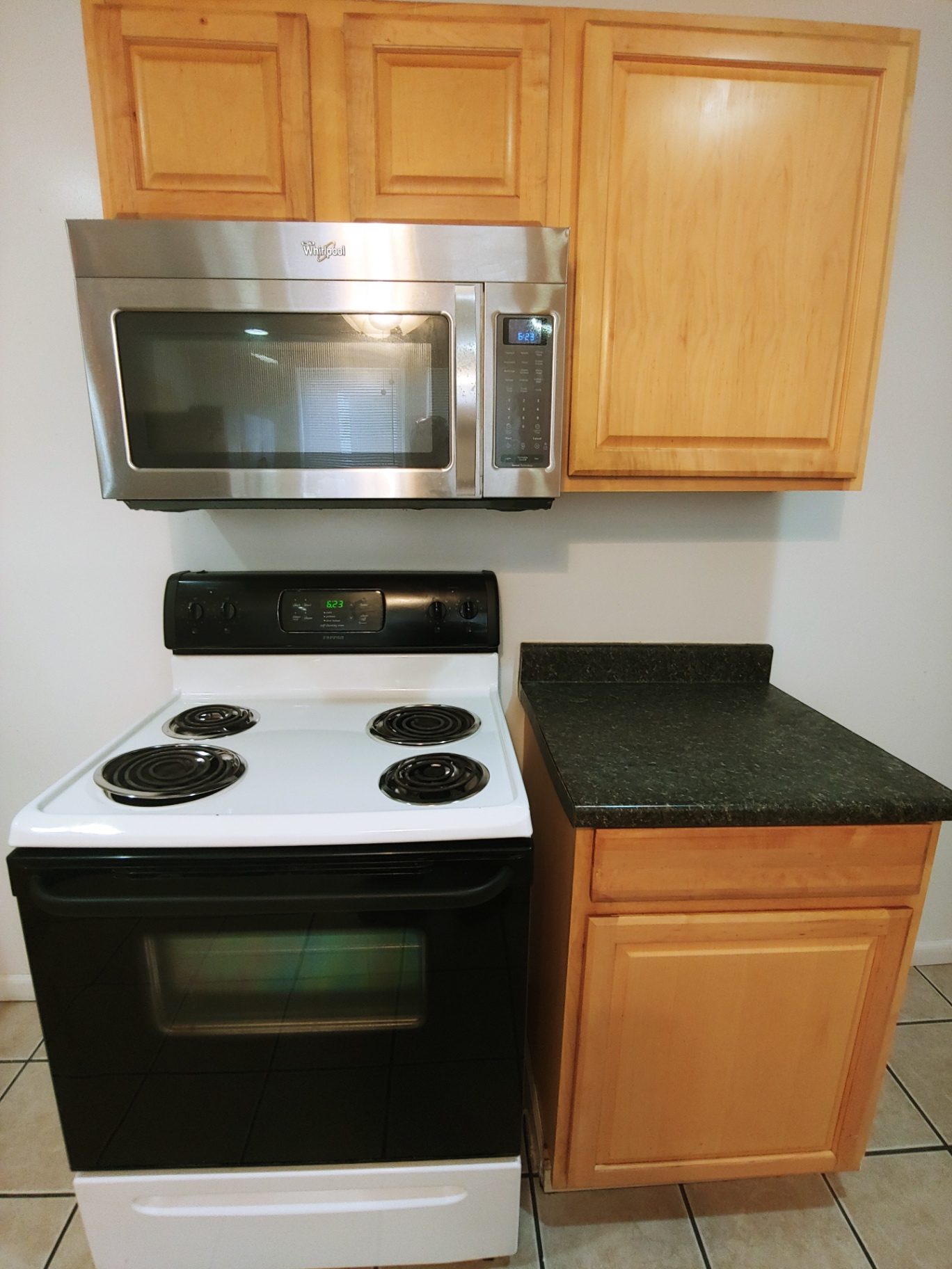 1818 Summit St. kitchen with electric range, over-range microwave, and granite counters