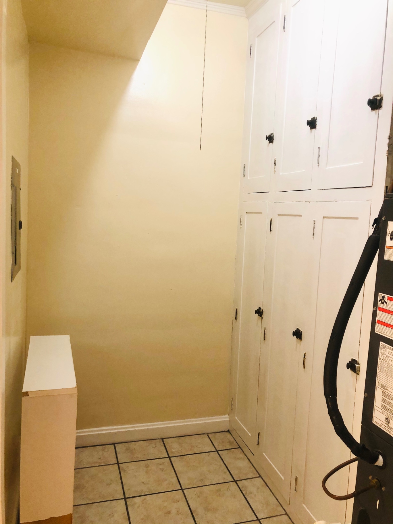 Unit L utility closet with built-in storage cabinets