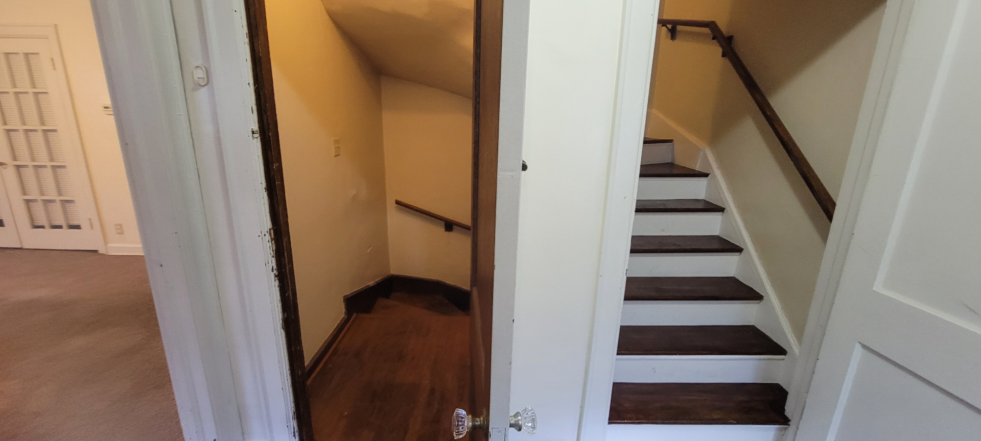 2044 Iuka Ave. D private staircase entry with original glass-knob door leading up to the loft bedroom
