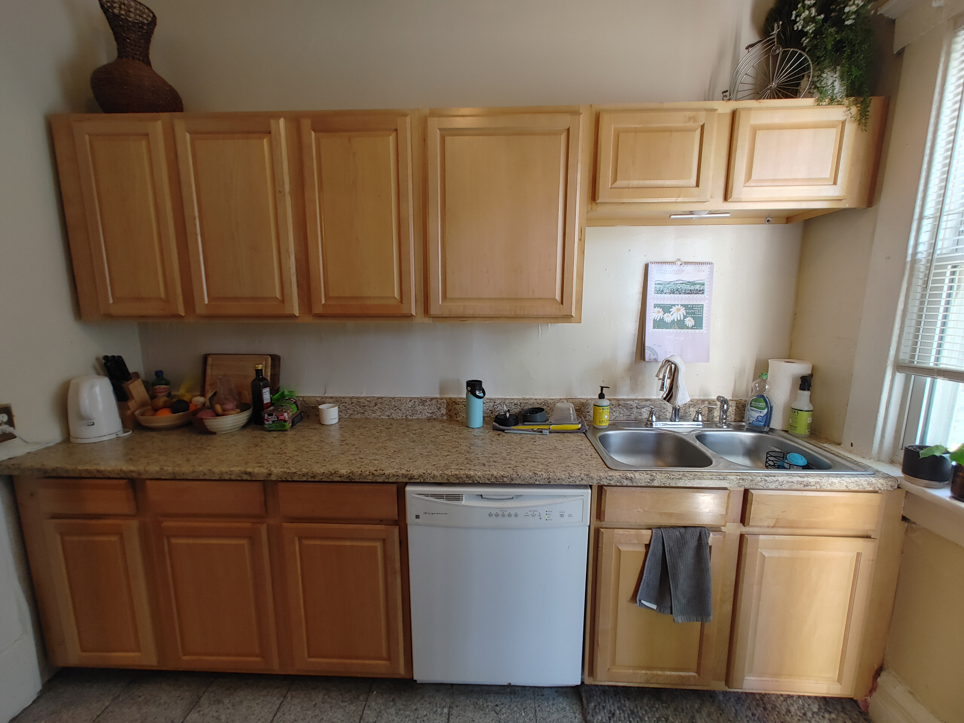 121 W 9th kitchen with wood cabinets, dishwasher, and double-basin sink