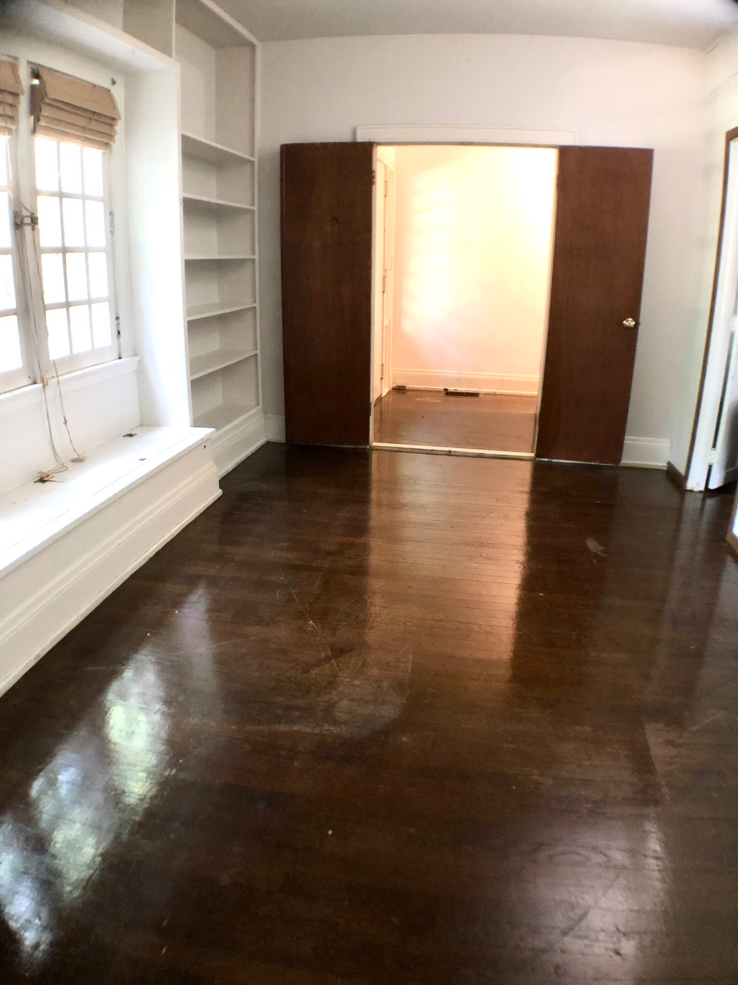 2026 Iuka Ave A bedroom with built-in bookshelves and pocket doors