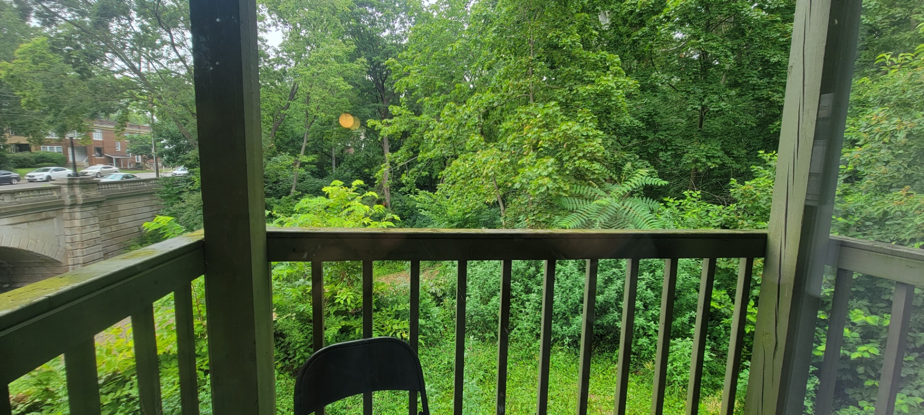 2022 Summit St. private balcony view over the lush green Iuka Ravine with a peek of the stone bridge