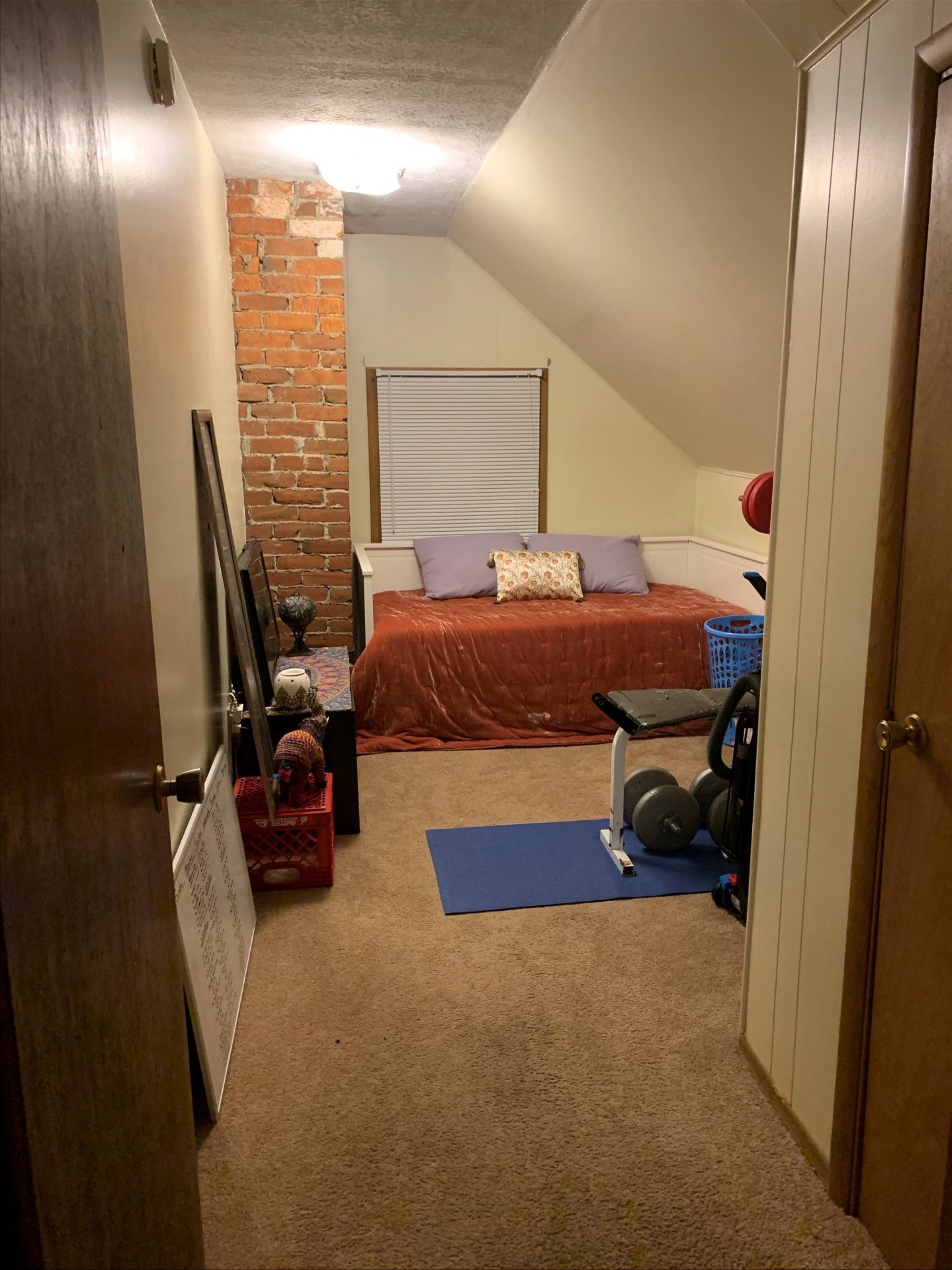 Flex room with exposed brick chimney, daybed, and window seating