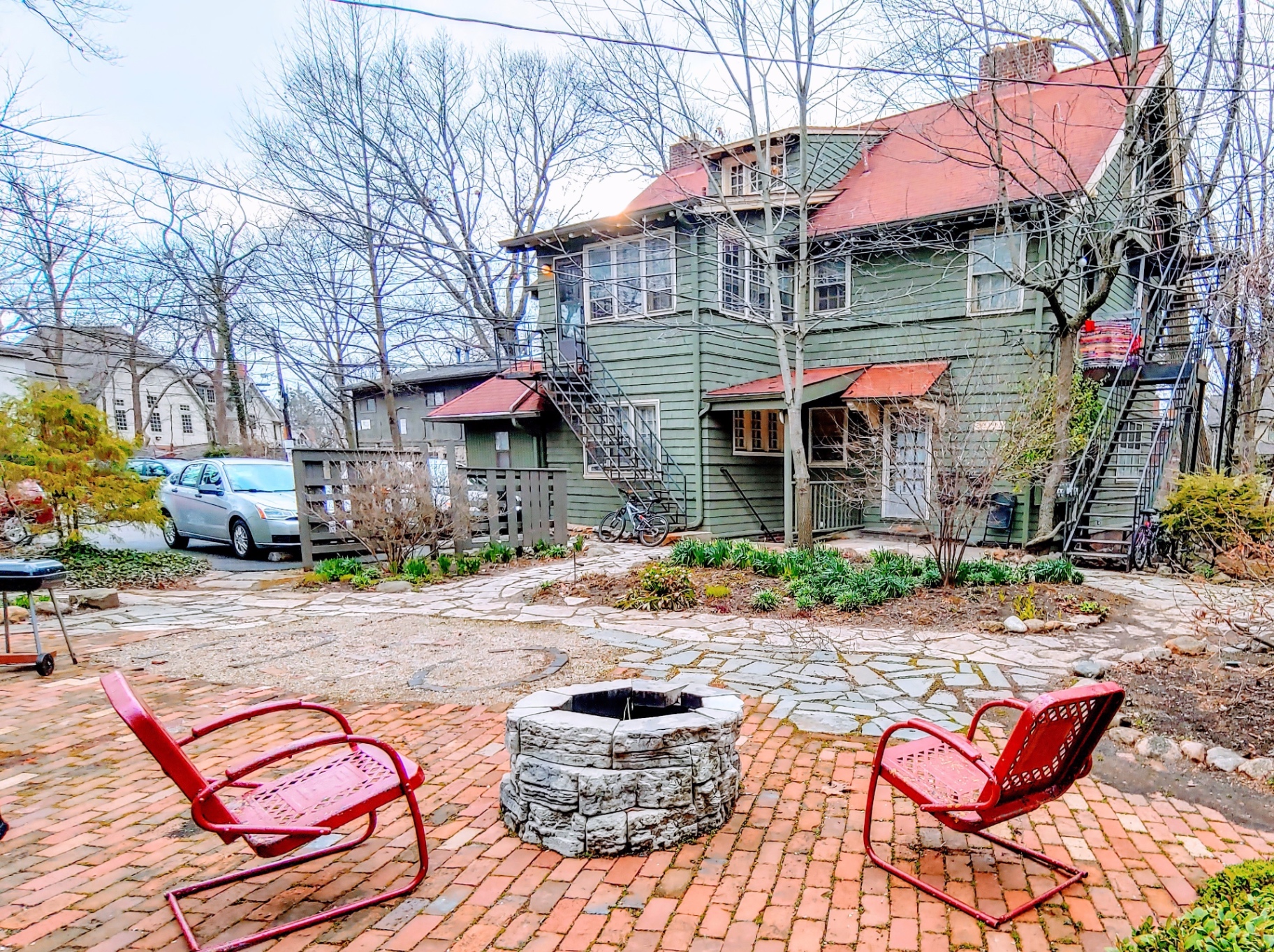 2026 Iuka Ave shared brick courtyard with fire pit and vintage red chairs