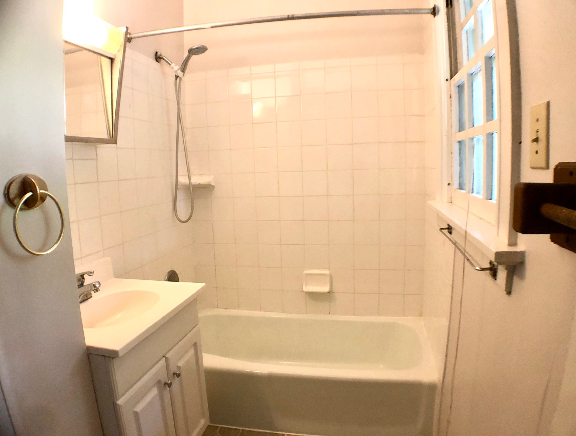 2026 Iuka Ave A tiled tub/shower with window and vanity