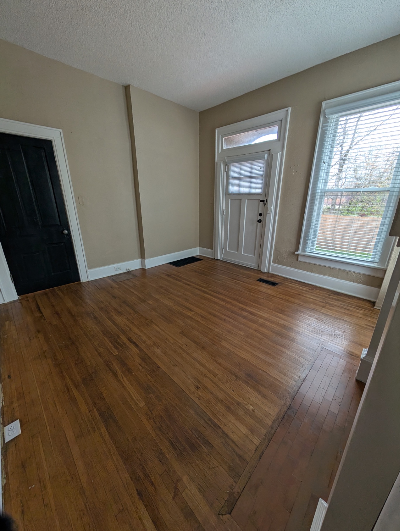 3338 Chestnut Downstairs entry foyer with hardwood floors and side door