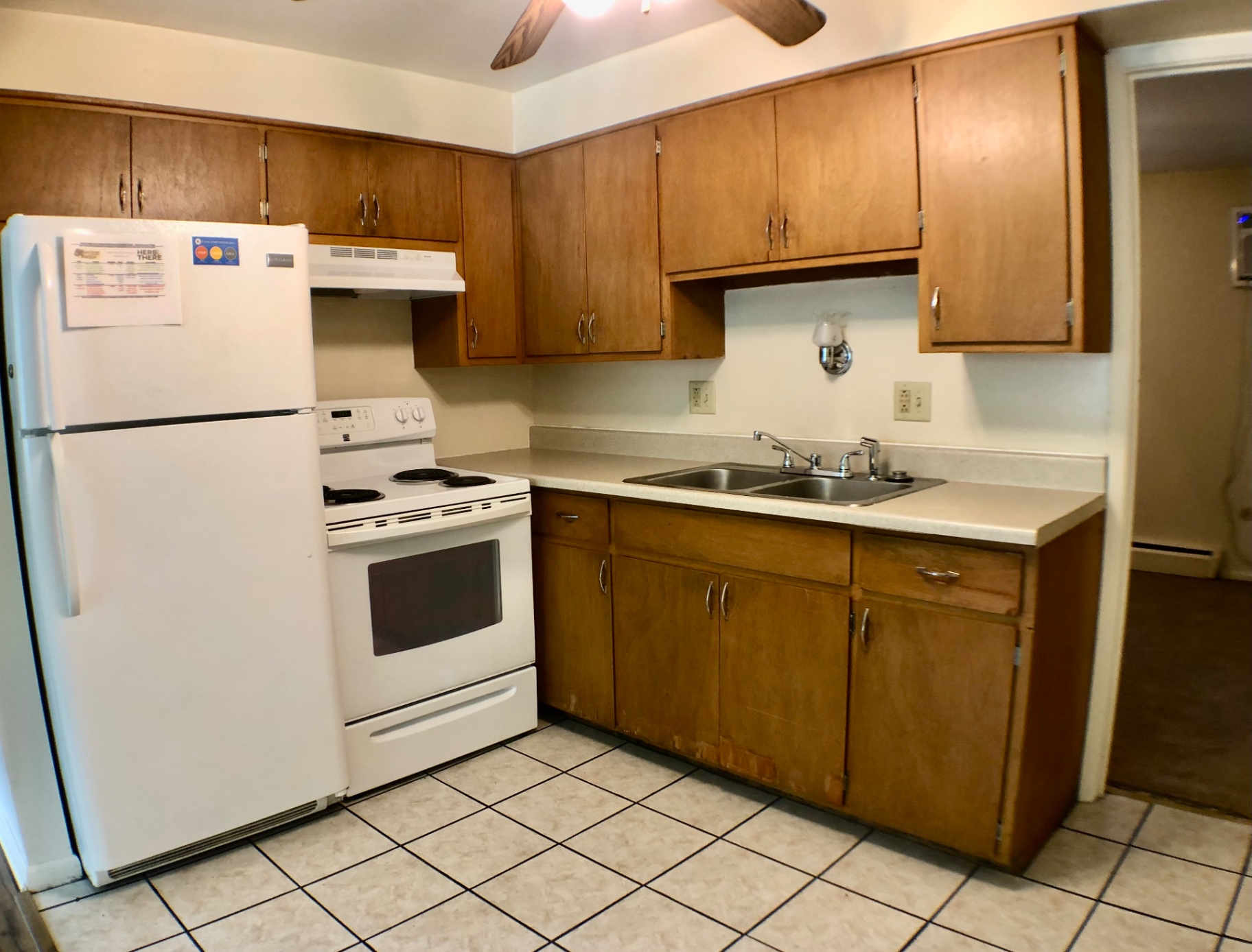 1827 N 4th St. Unit 1 kitchen with white appliances, electric range, and oak cabinets