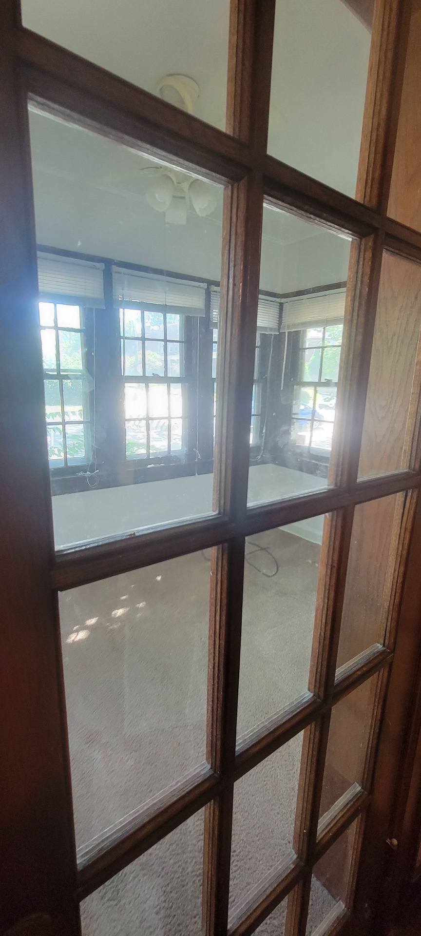 2054 Iuka Ave. A detail of original divided-light French door looking into the sunroom