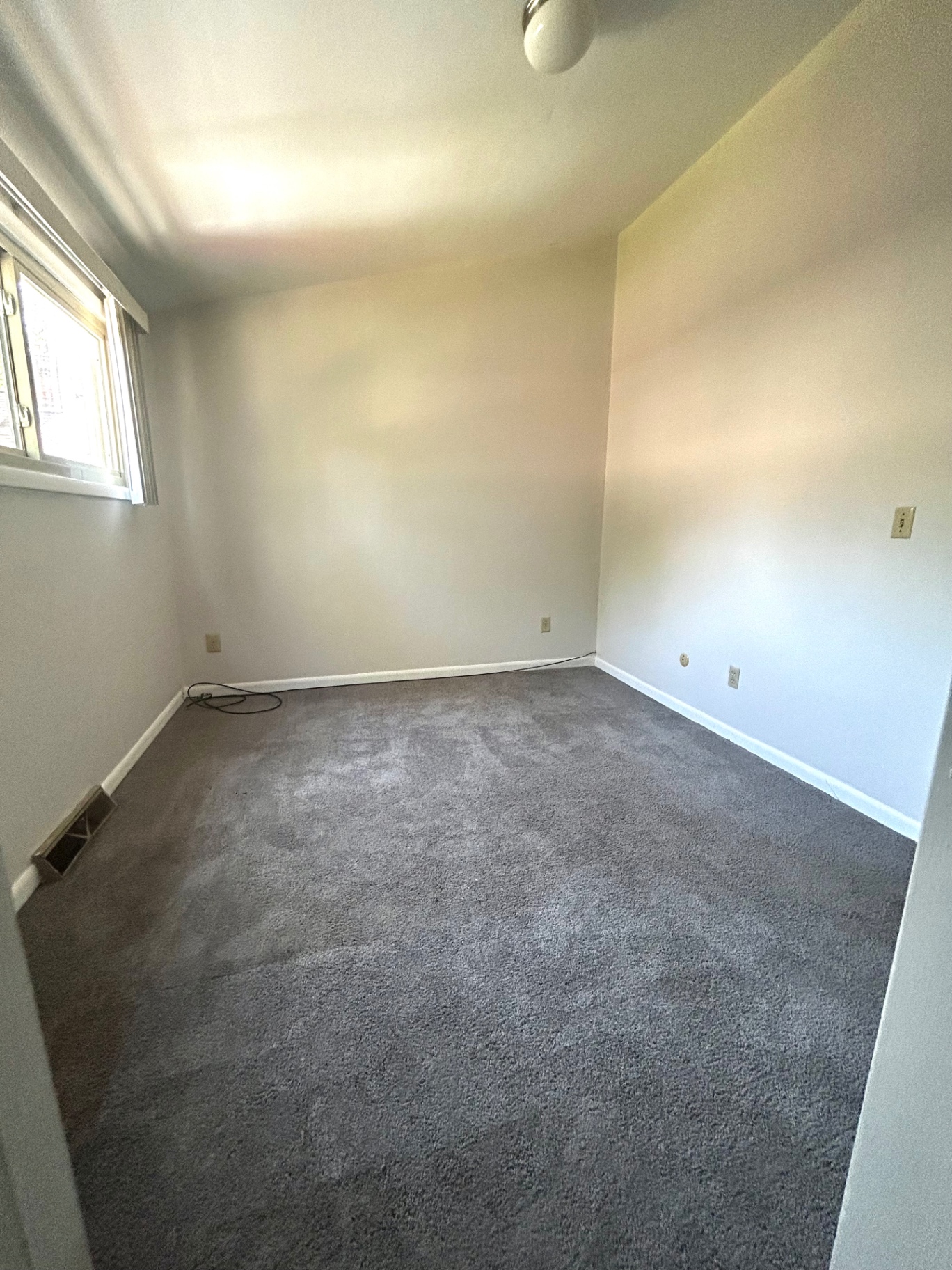 2011 Summit St. Unit E first bedroom from the window side with fresh gray carpet