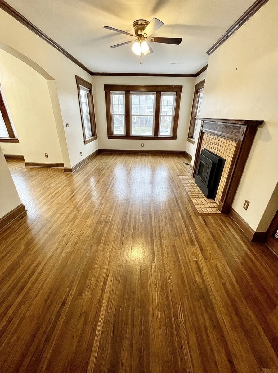 Unit D living room with gas fireplace, ceiling fan, and hardwood floors