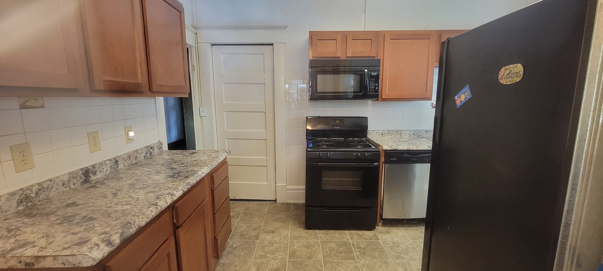2015 Summit St. kitchen with maple cabinets, gas range, dishwasher, and tile floor