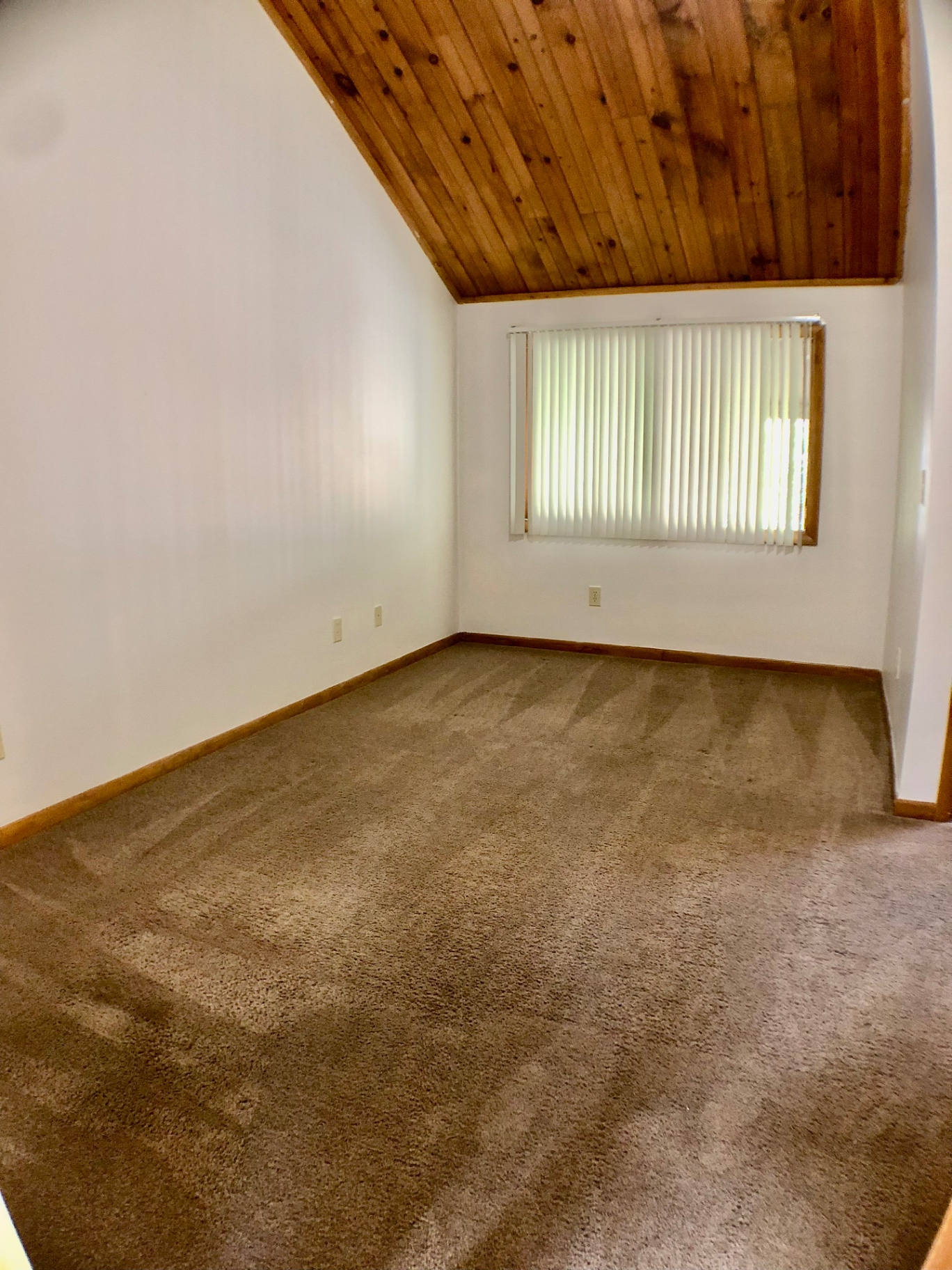 2040 Iuka Ave House bedroom with vaulted wood ceiling and large window