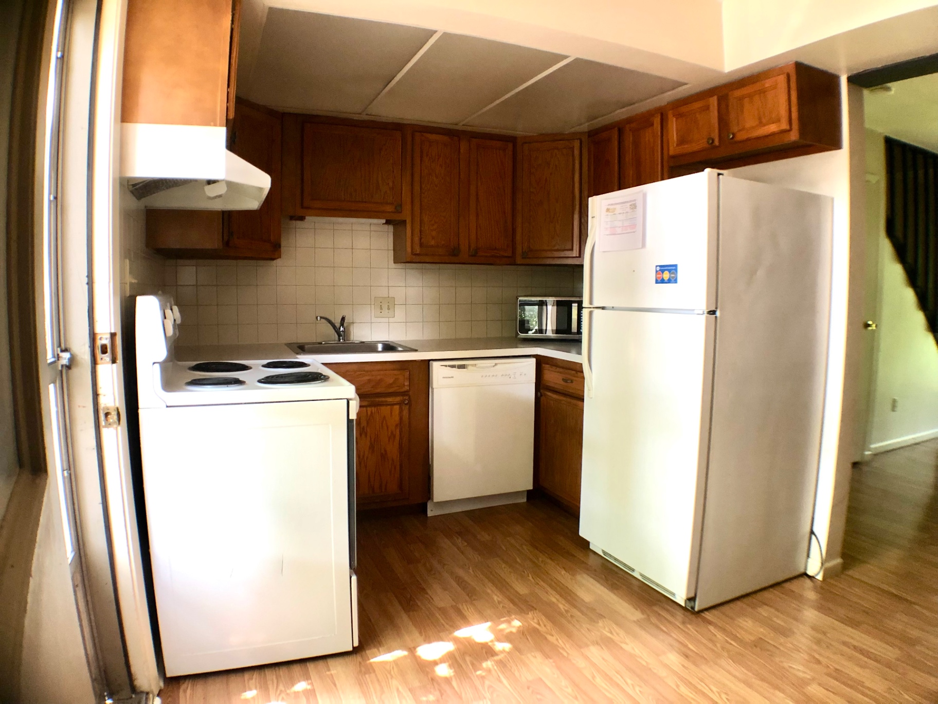 2018 Iuka Ave. kitchen with dishwasher, full-size refrigerator, microwave, and wood cabinets