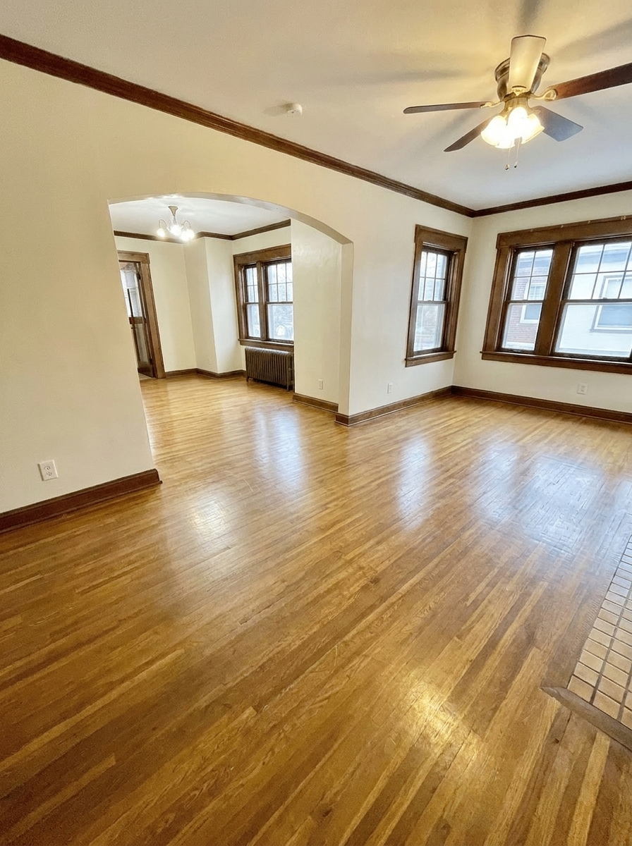 Unit D open living and dining area with archway and large windows