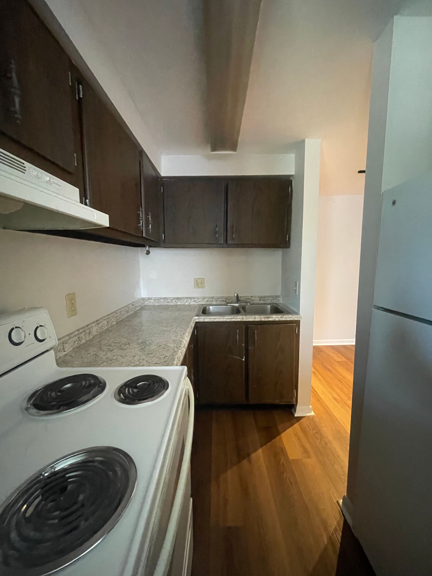 2020 Summit St. updated kitchen with dark cabinets, granite-look counters, double stainless sink, and full-size appliances