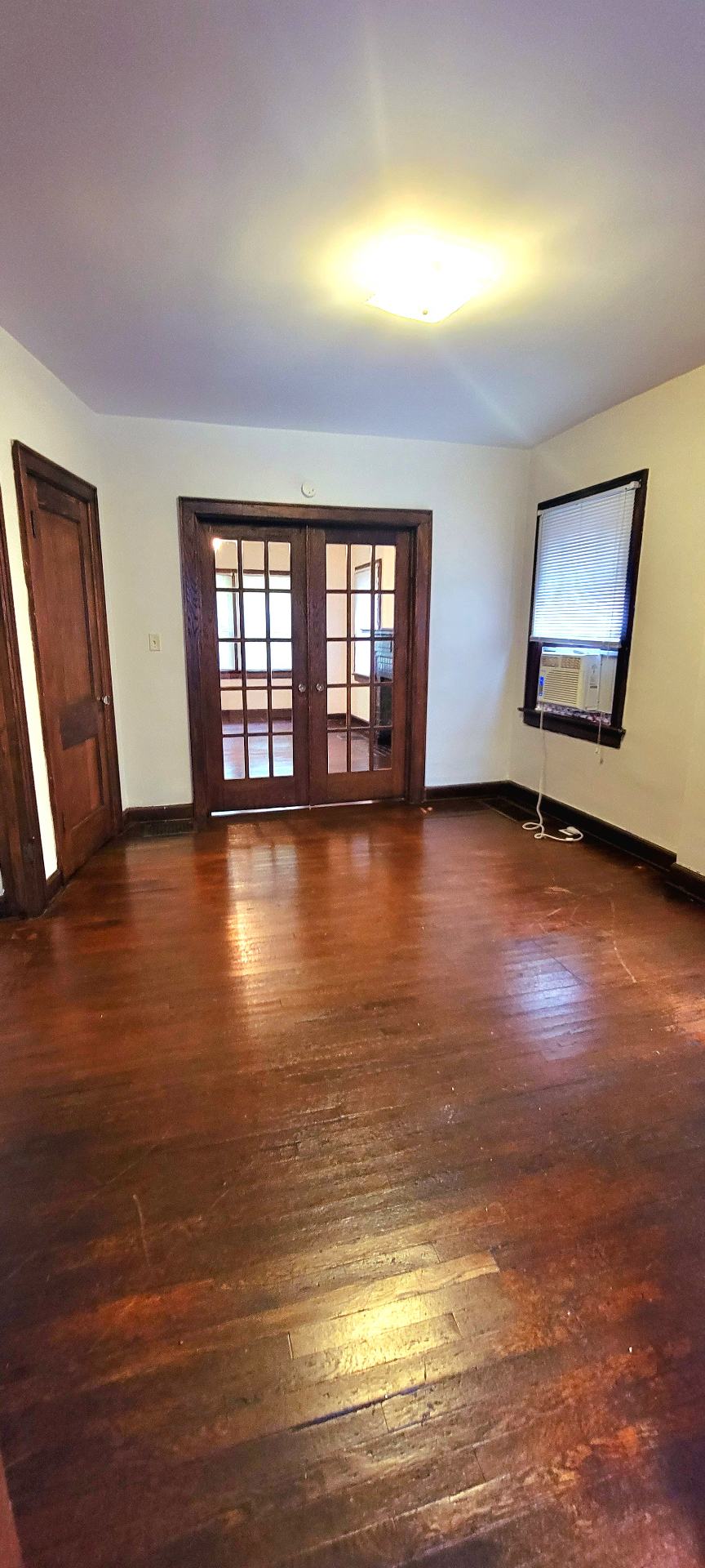 2048 Iuka Ave. A dining room with French doors, original woodwork, and hardwood floors