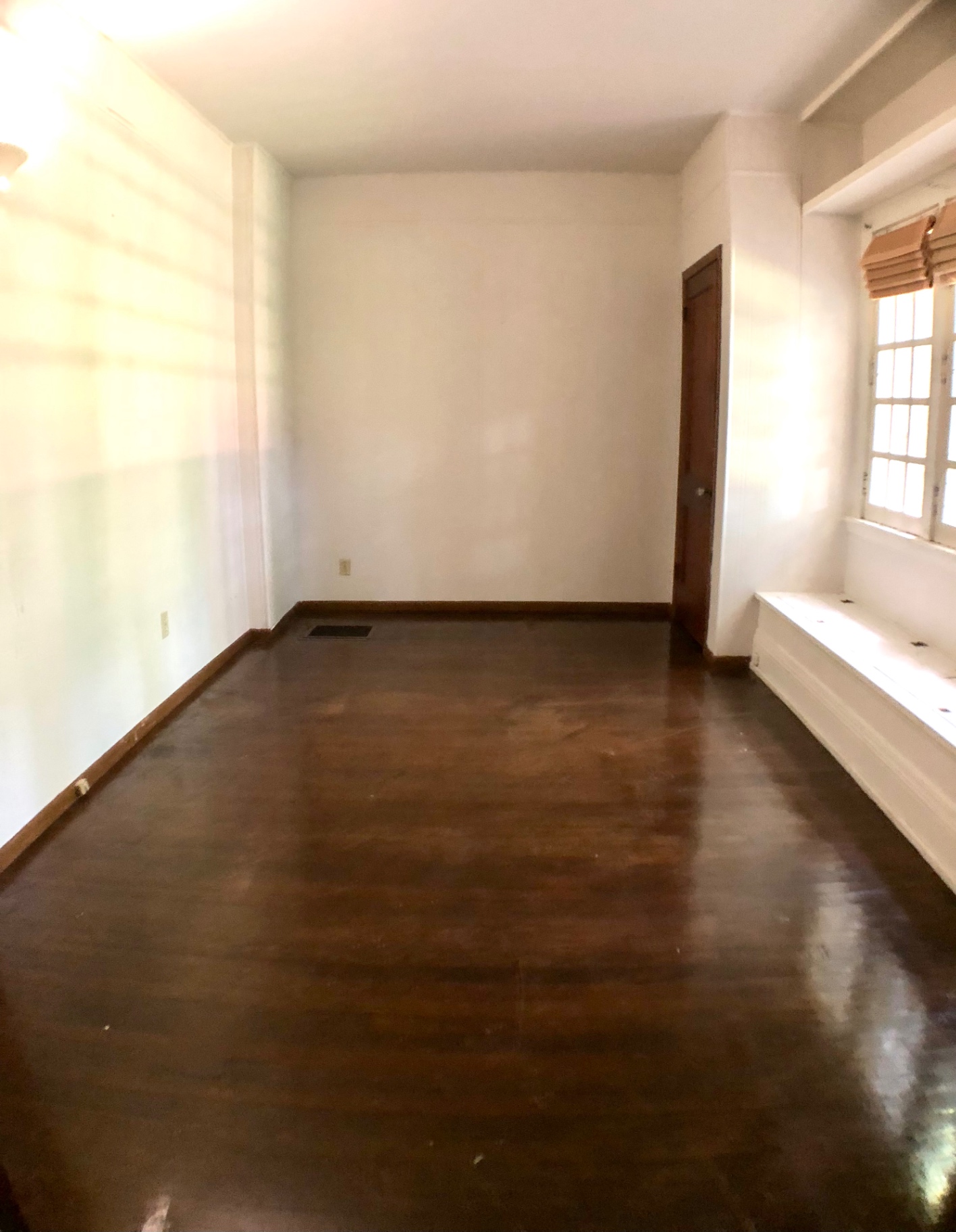 2026 Iuka Ave A bedroom with refinished hardwood floors and built-in window seat