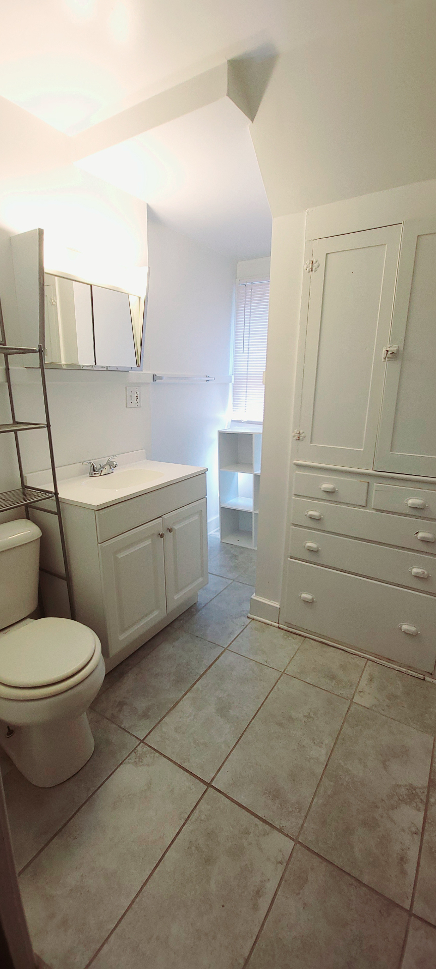 2054 Iuka Ave. C bathroom vanity area with built-in cabinet storage and tiled floor