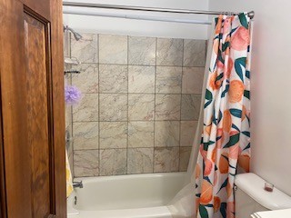 1827 N 4th St. Unit 7 tiled tub/shower with modern shower curtain