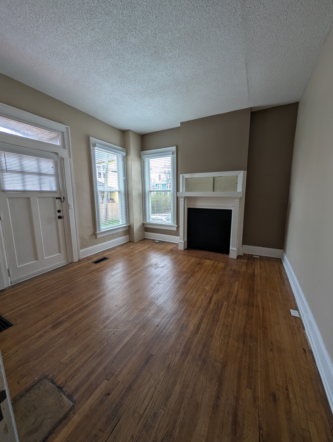 3338 Chestnut Downstairs living room with hardwood floors, decorative fireplace and bay windows