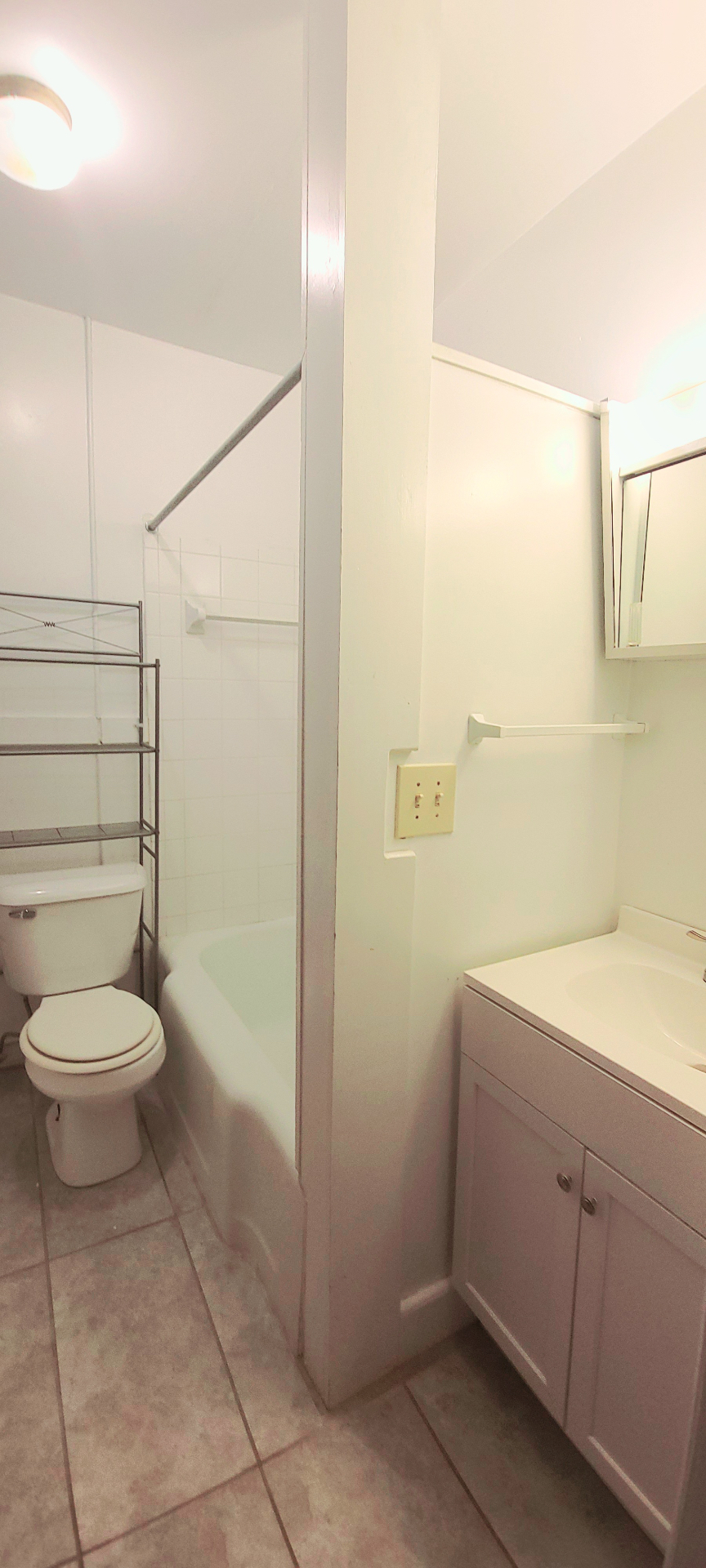 2054 Iuka Ave. C second bathroom with tub, toilet, and vanity