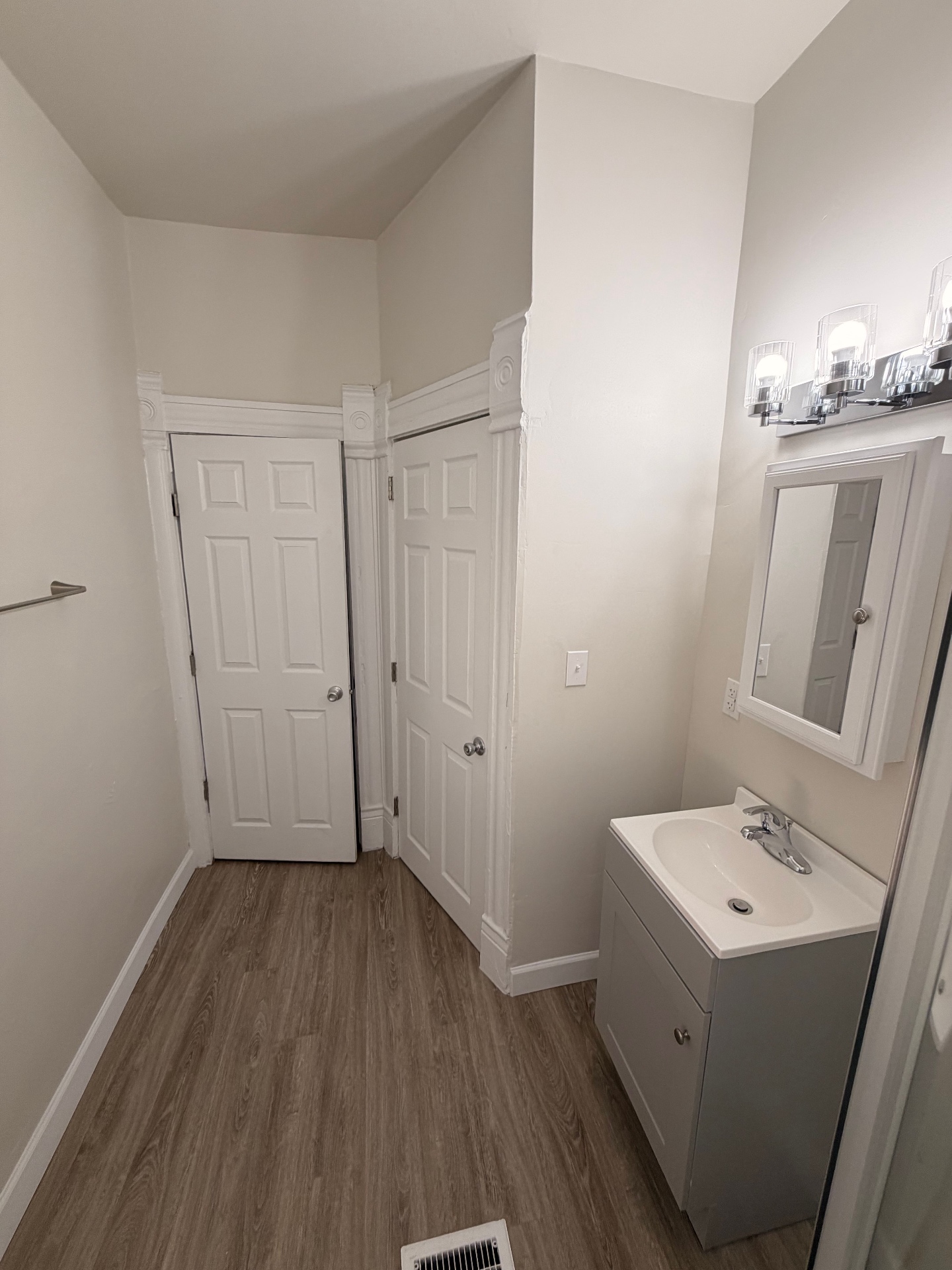 133½ bathroom entry with vanity, medicine cabinet and closet doors