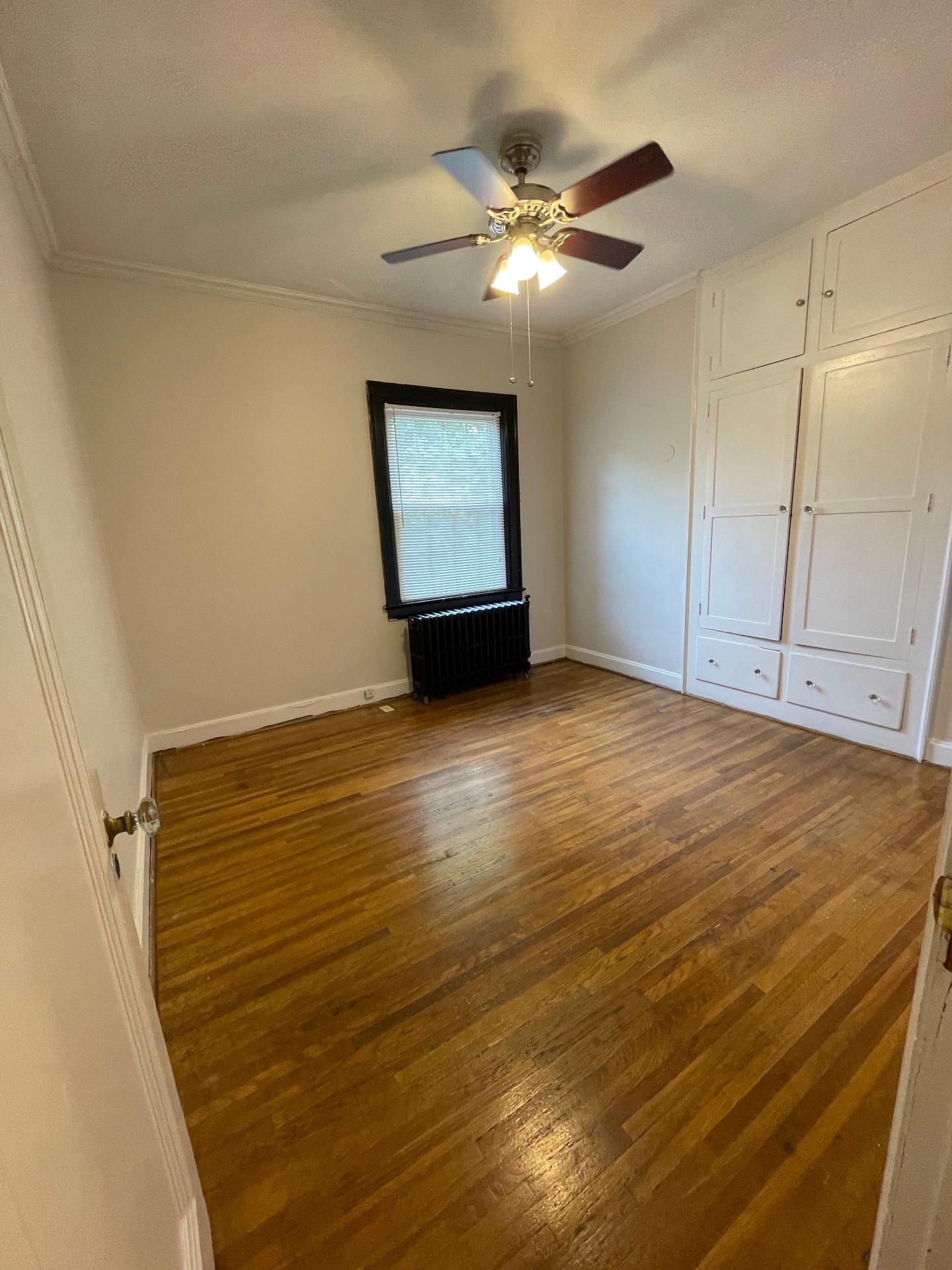 Unit E second bedroom with built-in cabinetry