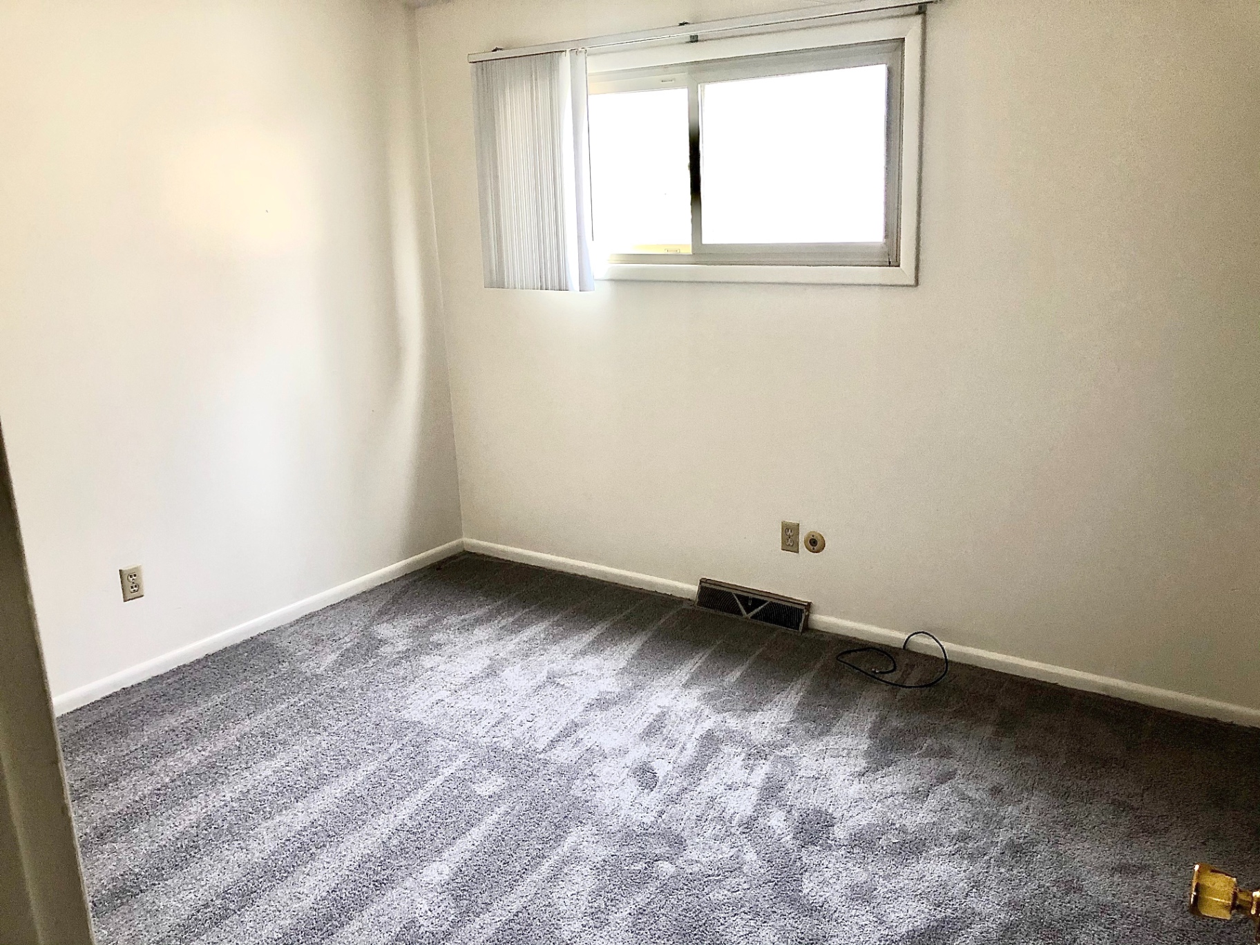 2011 Summit St. Unit C second bedroom with fresh gray carpet and bright window