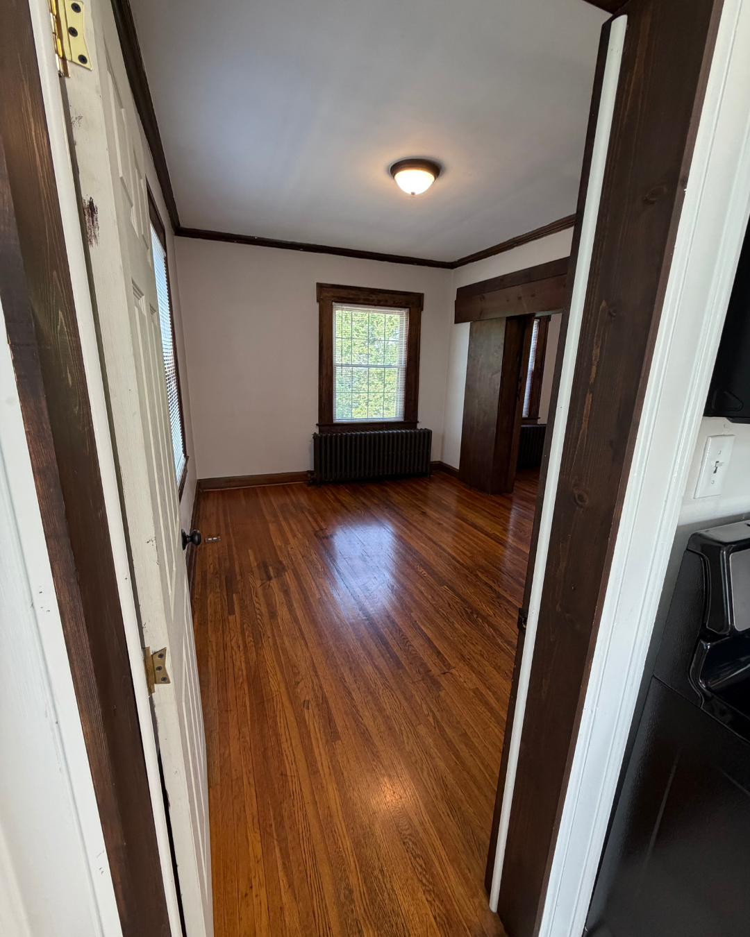 Bedroom entrance with dark wood trim and bright natural light