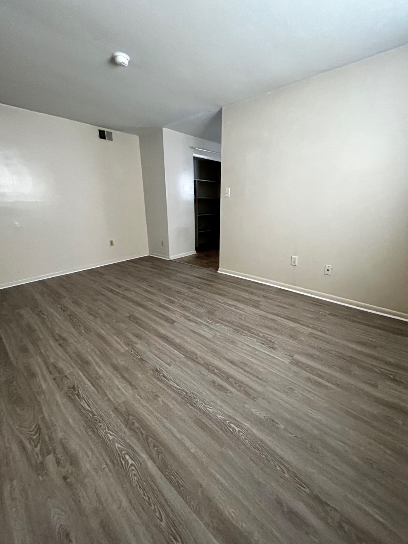 2150 N 4th St. Unit B bedroom with plank flooring and walk-in closet with shelving