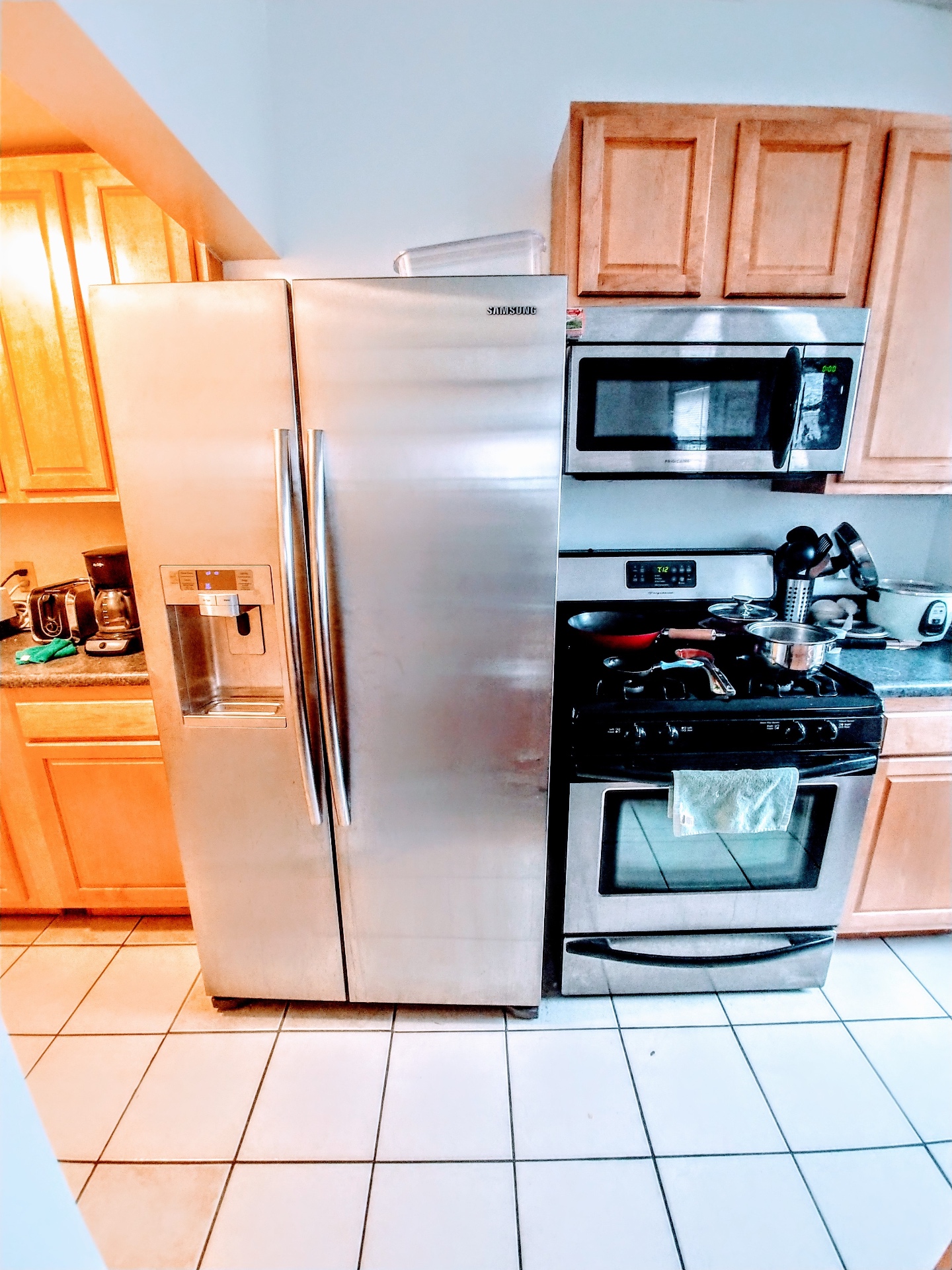 Unit K kitchen with stainless steel appliances, gas range, and maple cabinets