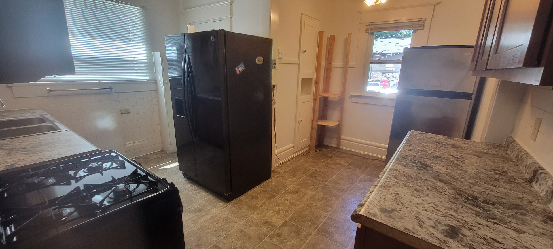 2015 Summit St. kitchen with two refrigerators, gas stove, and pantry storage