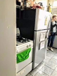 115 W 9th kitchen with gas range and full-size refrigerator