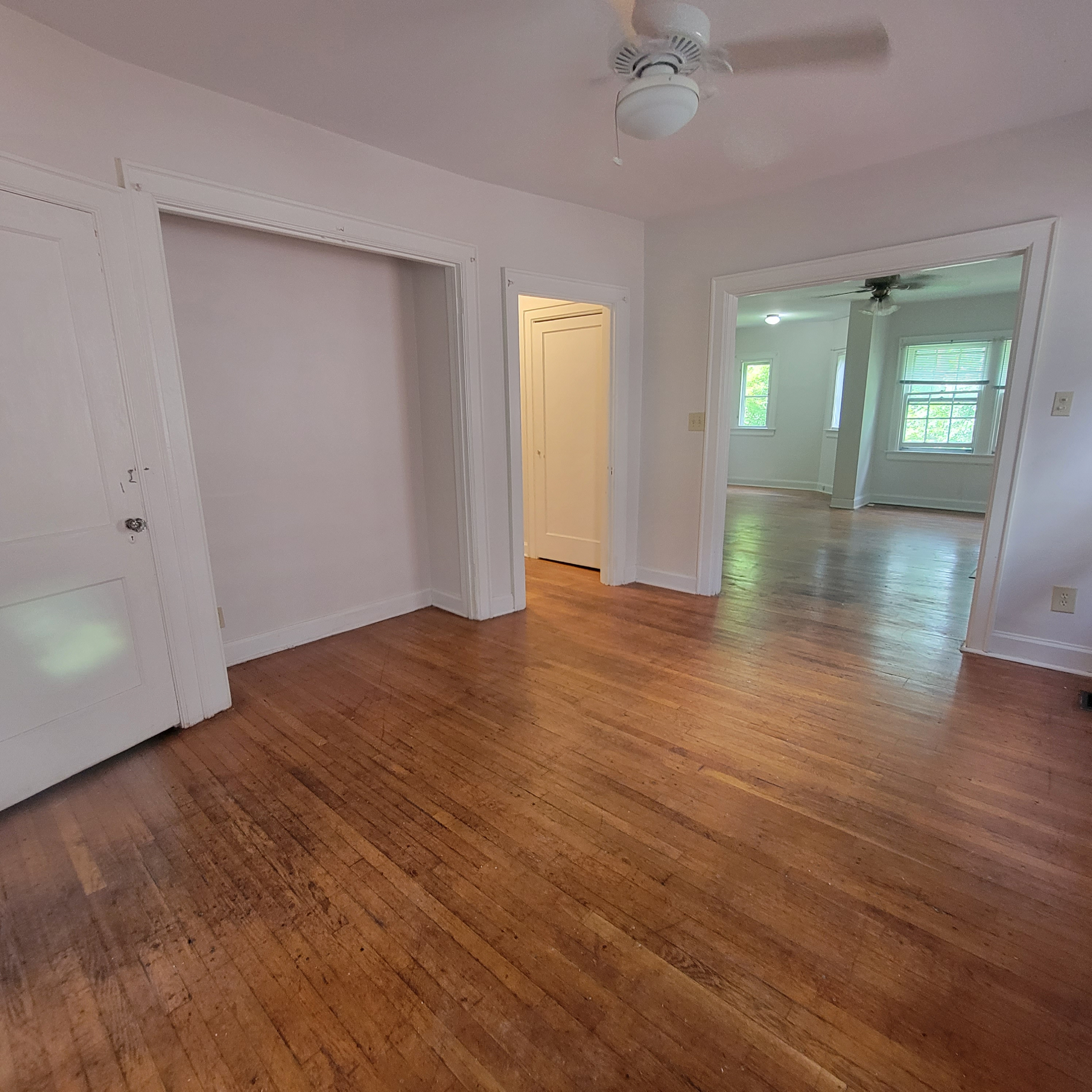 2048 Iuka Ave. C bedroom view opening toward the connected living area with hardwood floors throughout