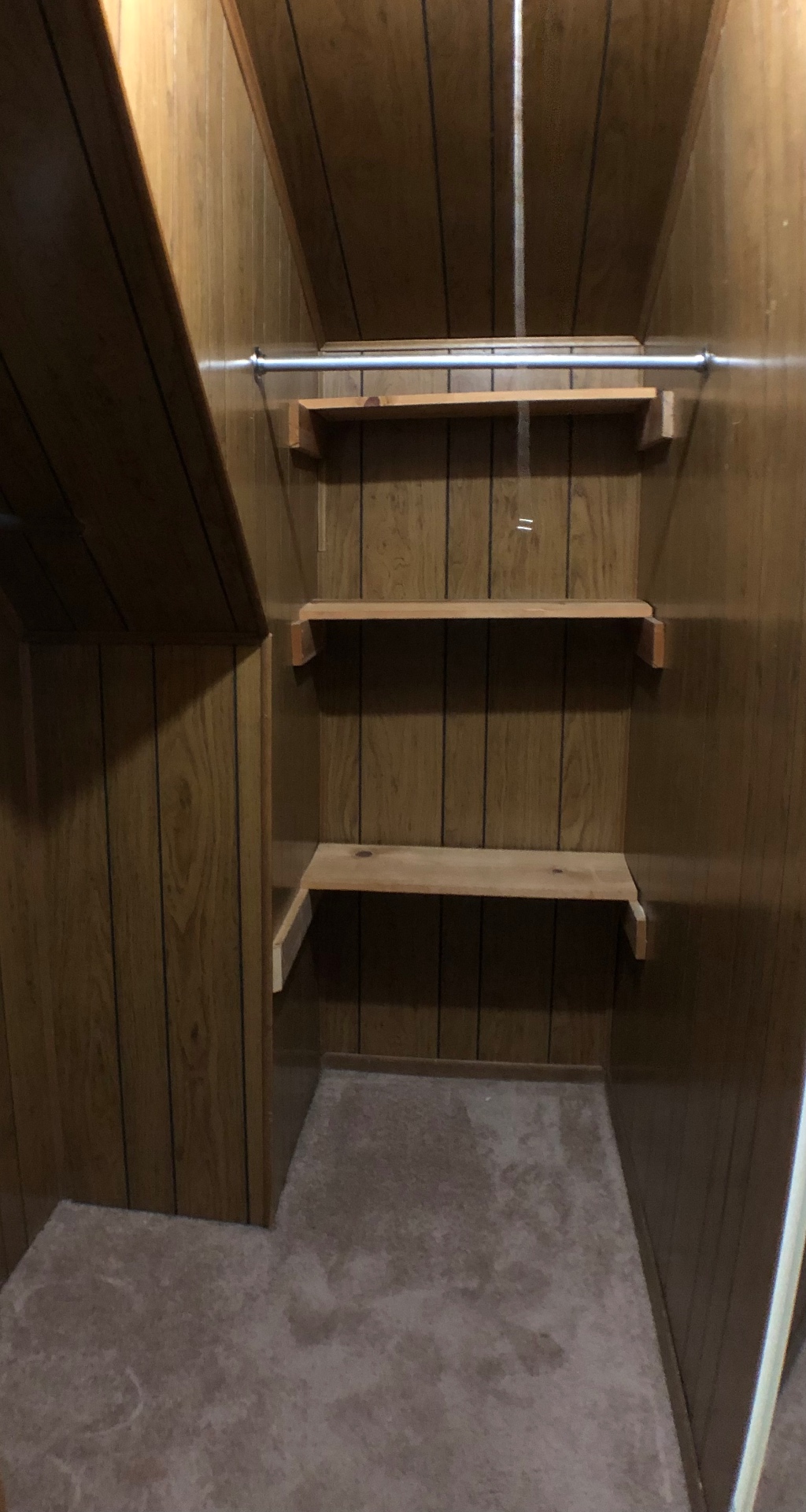Cedar-panel walk-in closet with built-in shelves and hanging rod