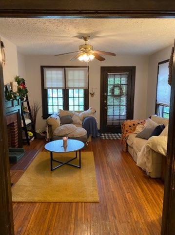2155 N 4th St. living room with hardwood floors, ceiling fan, and front door
