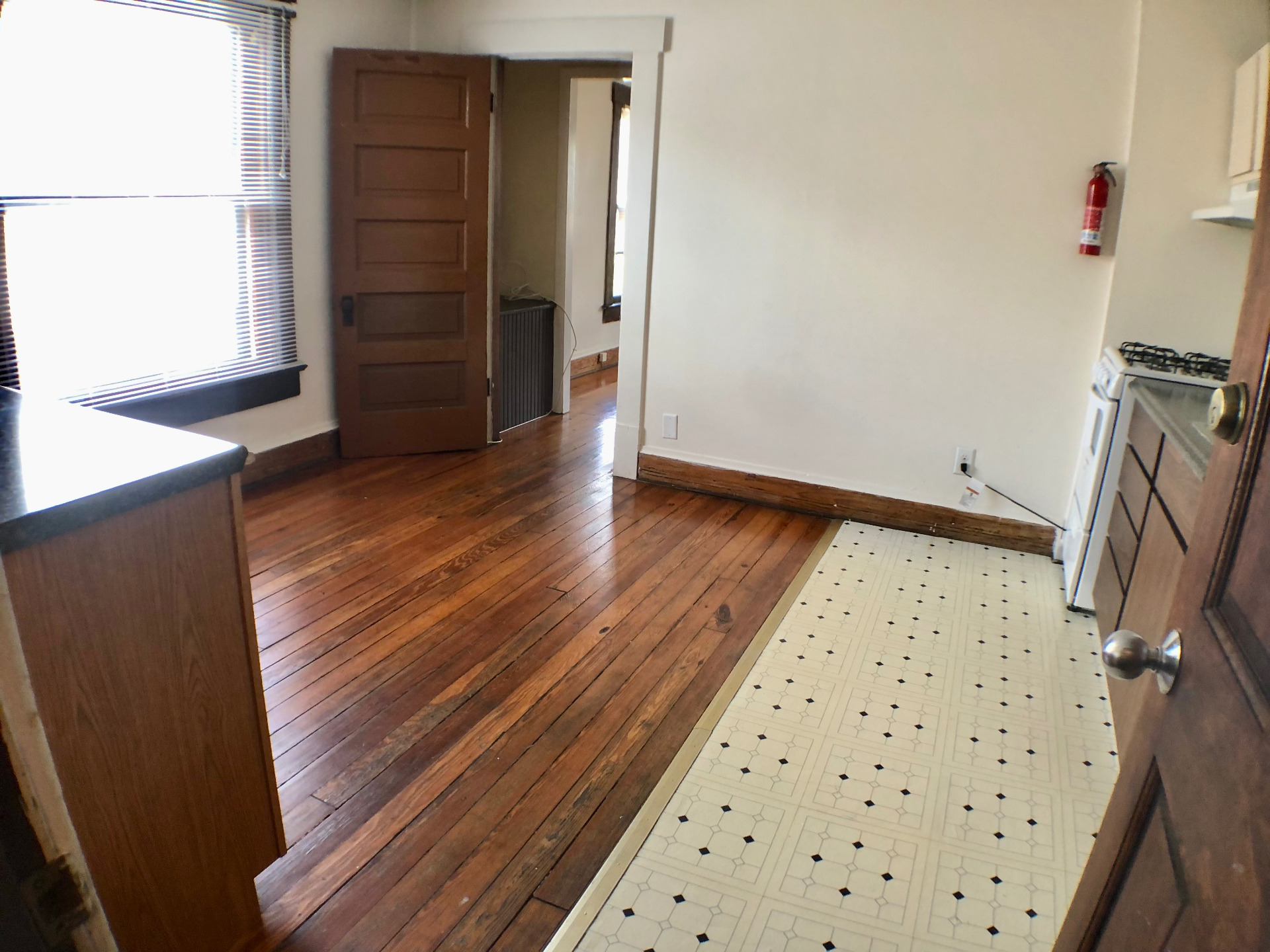 89 E Woodruff Ave. Unit A kitchen and dining area with tile floor, gas range, and original wood doors