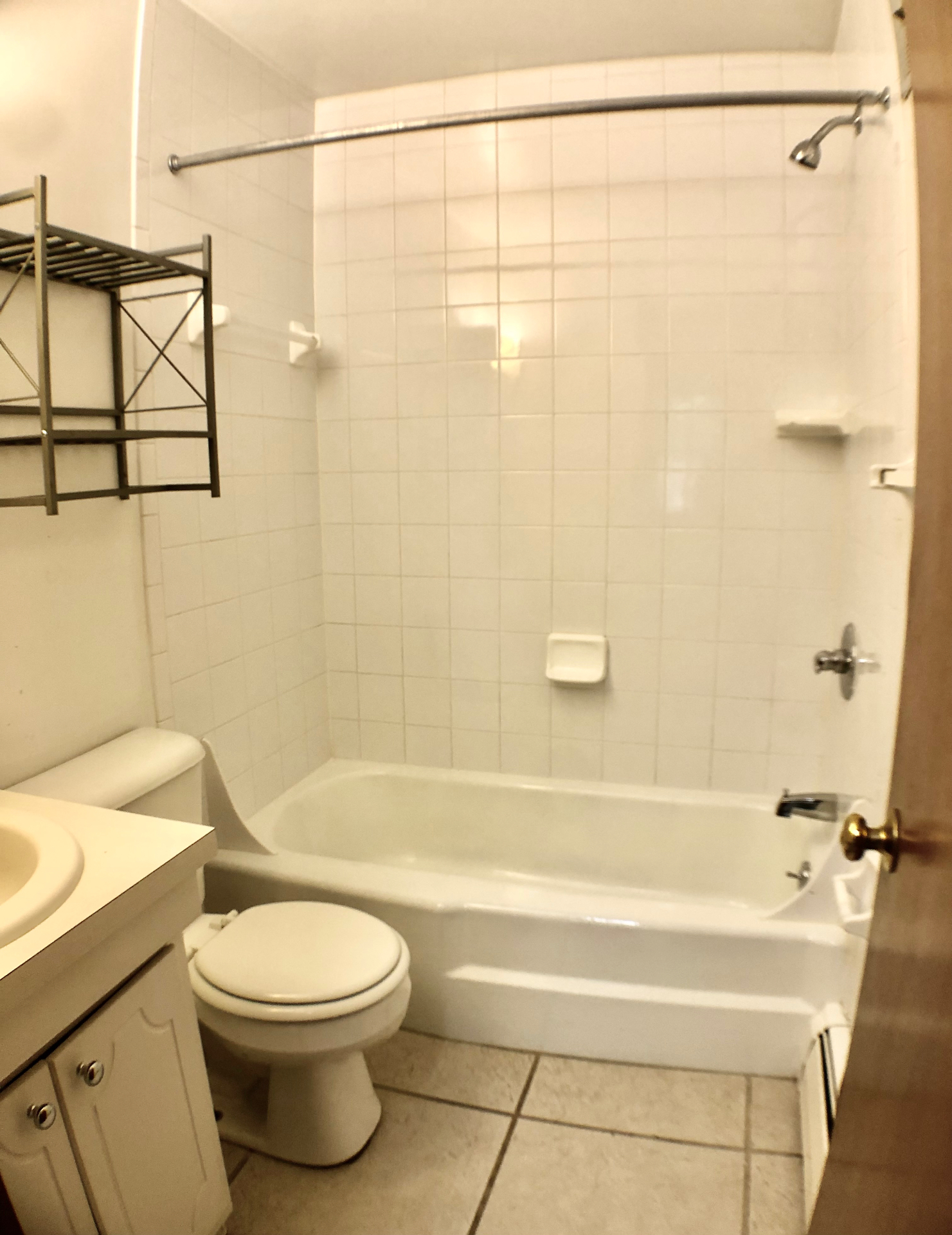 2040 Iuka Ave. 5A bathroom with white tiled tub-shower combo and vanity