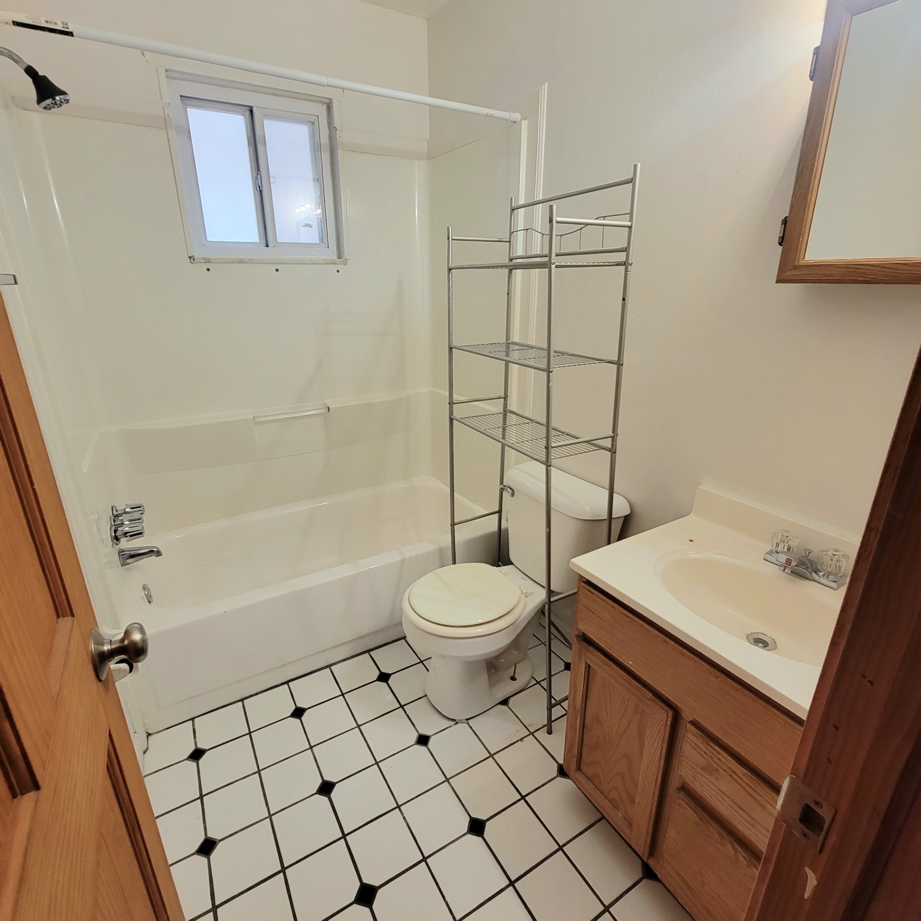 2150 N 4th St. Unit E bathroom with tub/shower, oak vanity, and tile floor
