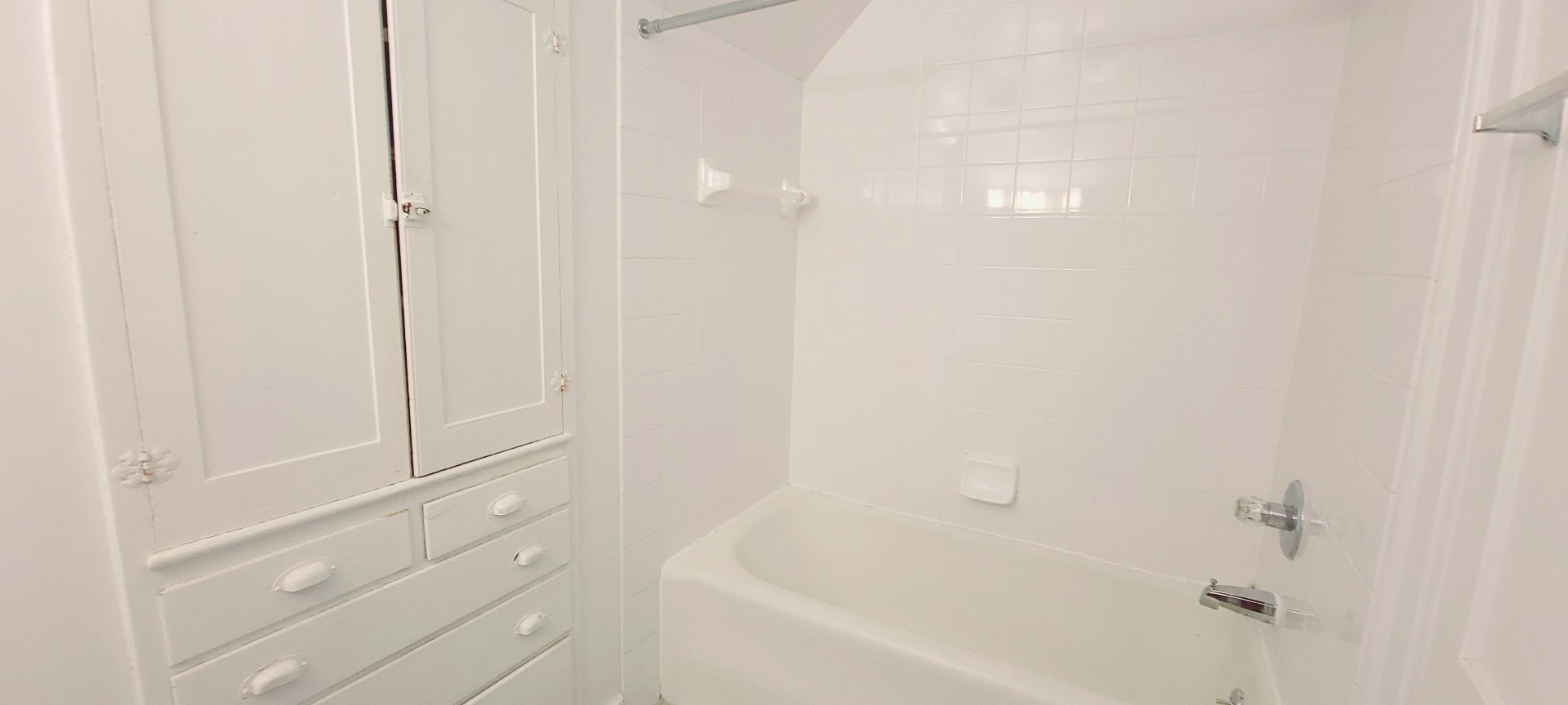 2054 Iuka Ave. C full bathroom with tub surround and built-in storage cabinetry