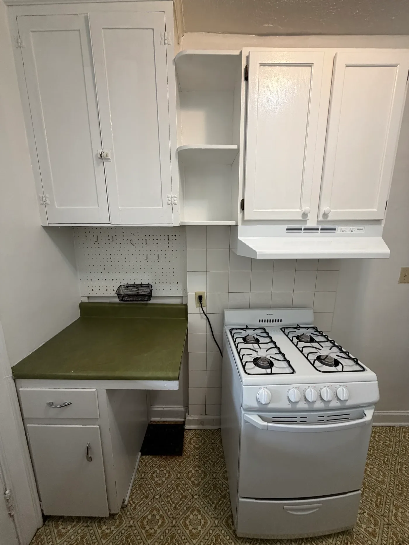 2048 Iuka Ave. D kitchen with gas range, vent hood, tile backsplash, and extra counter space