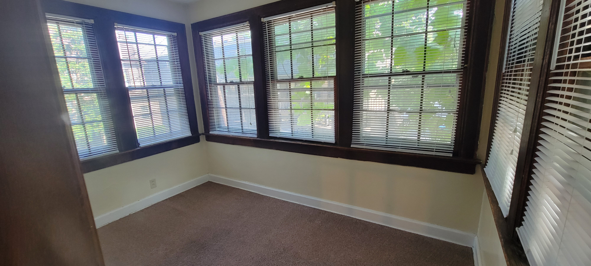 2044 Iuka Ave. D bright bonus room with a wall of dark-trim windows overlooking the ravine trees
