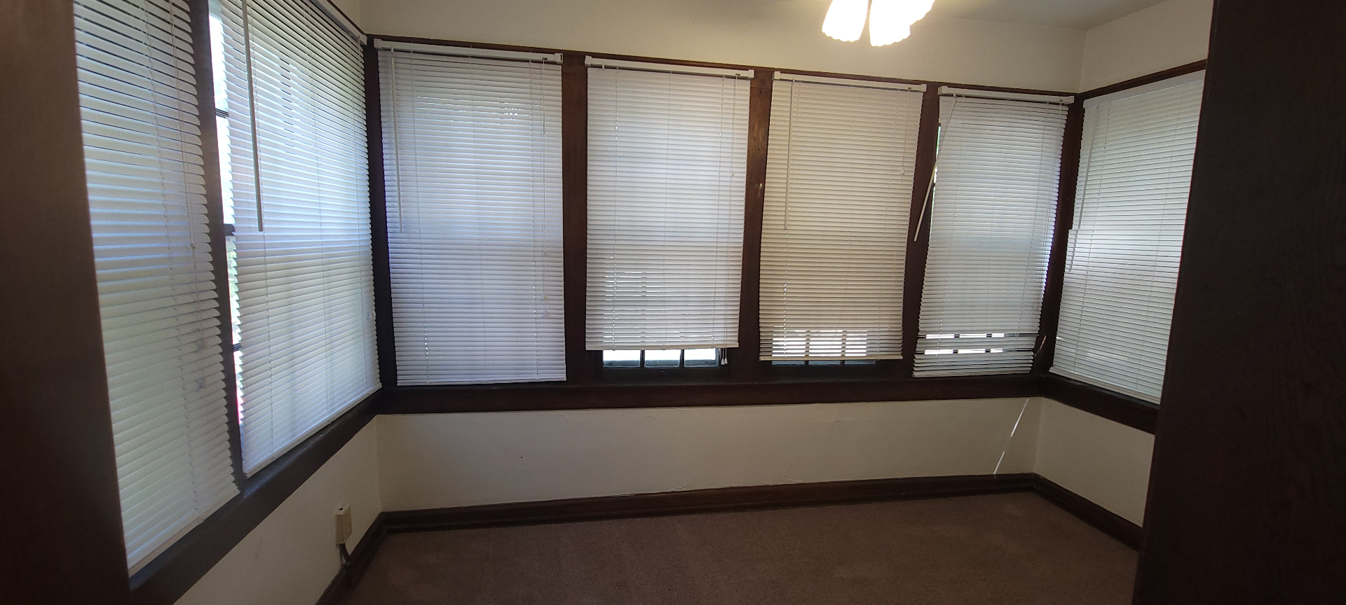 2054 Iuka Ave. C sunroom lined with windows on three sides — bright, versatile flex space