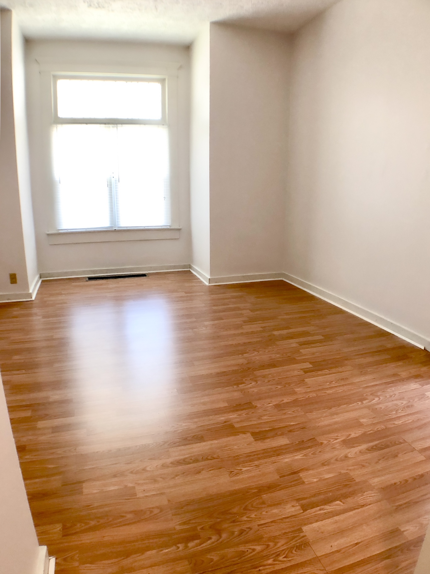 Unit A bright room with hardwood floors and window seat